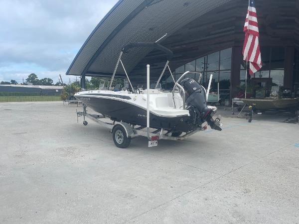 2022 Hurricane SS185 OB boat on trailer outside a building with an American flag.
