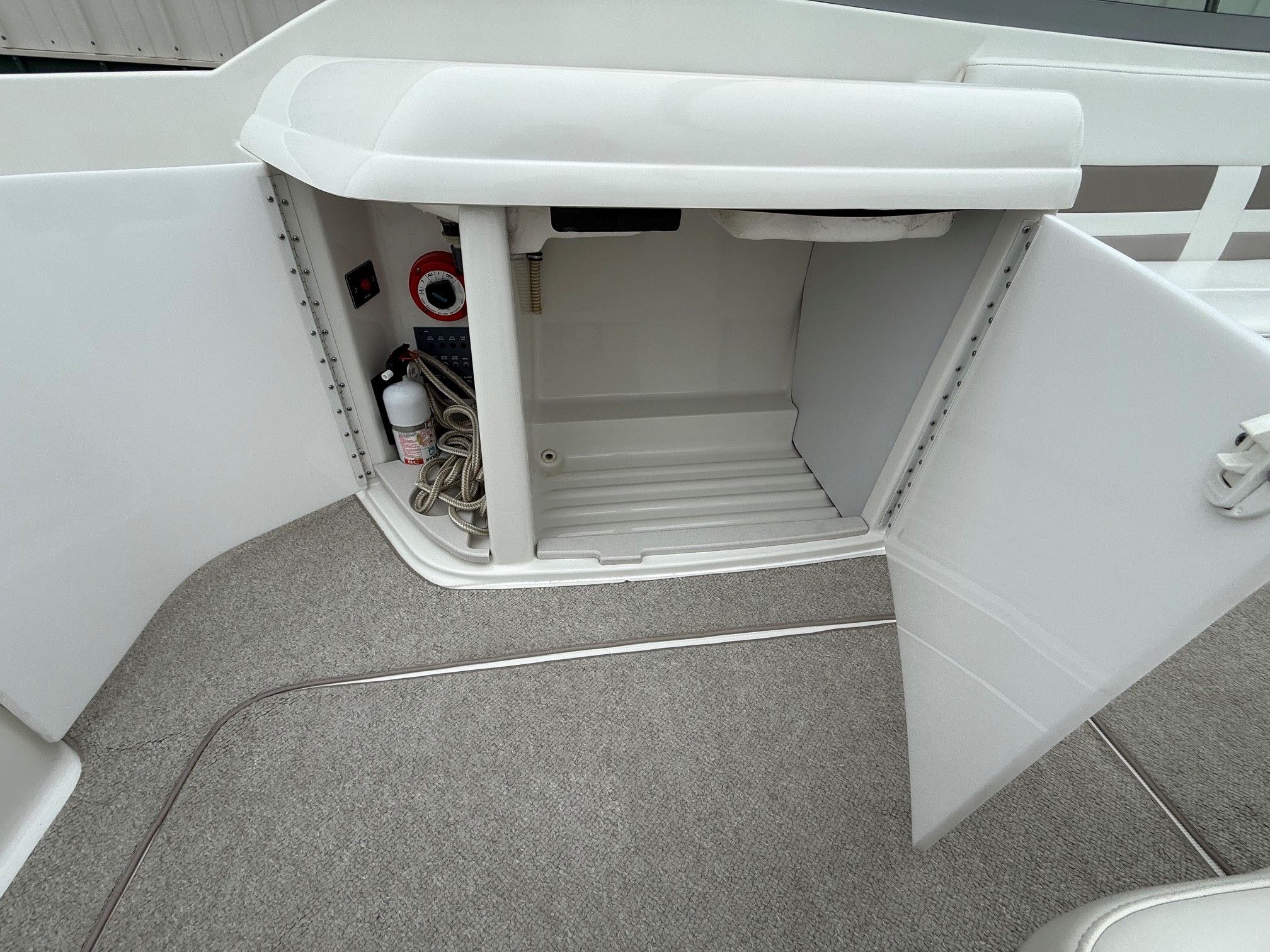 Open storage compartment on a 1998 Formula Thunderbird boat.