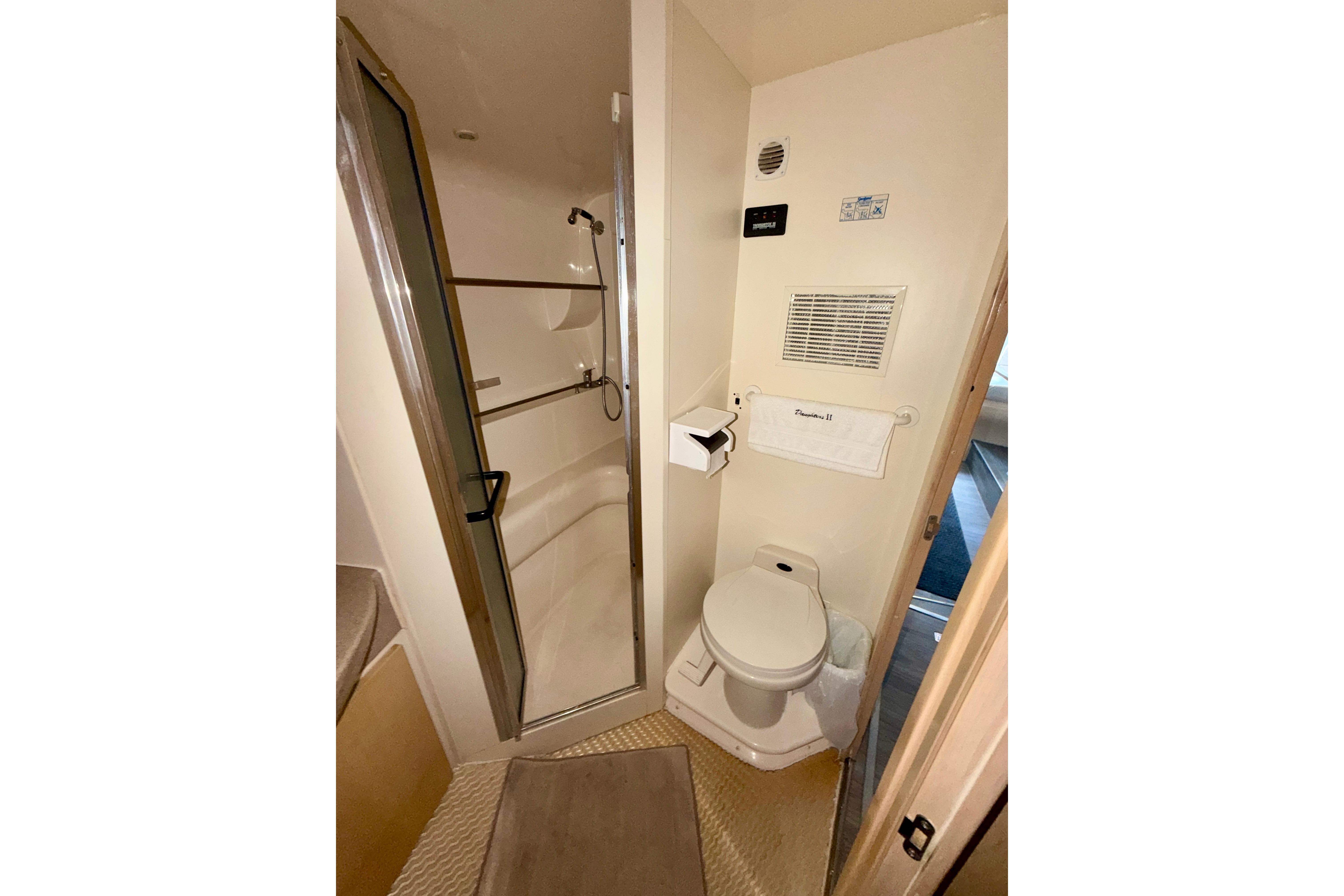 Bathroom interior of 2000 Carver 350 Mariner yacht, featuring shower and toilet.