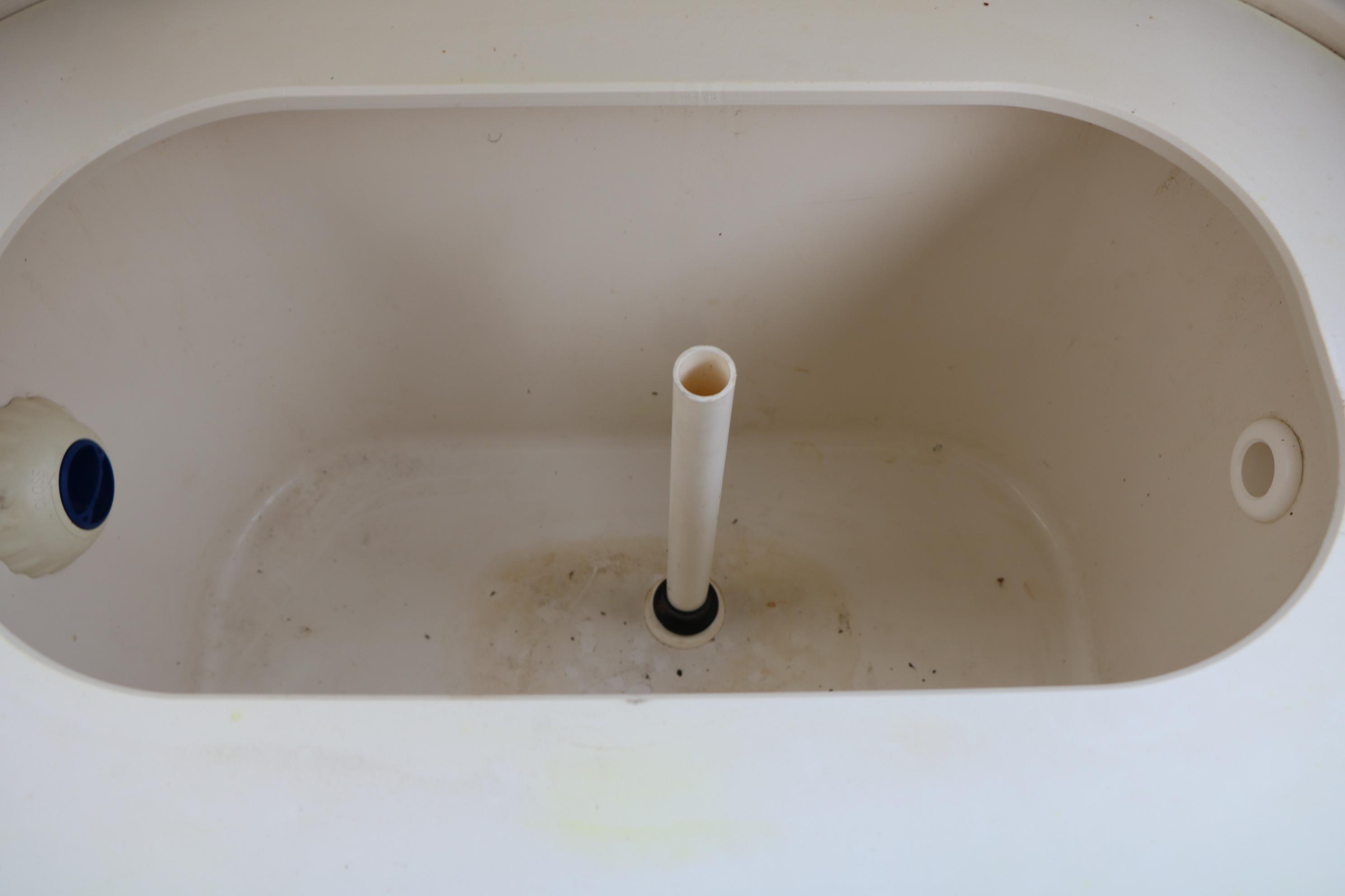2022 Stingray 192 SC boat compartment with drainage pipe and plug.