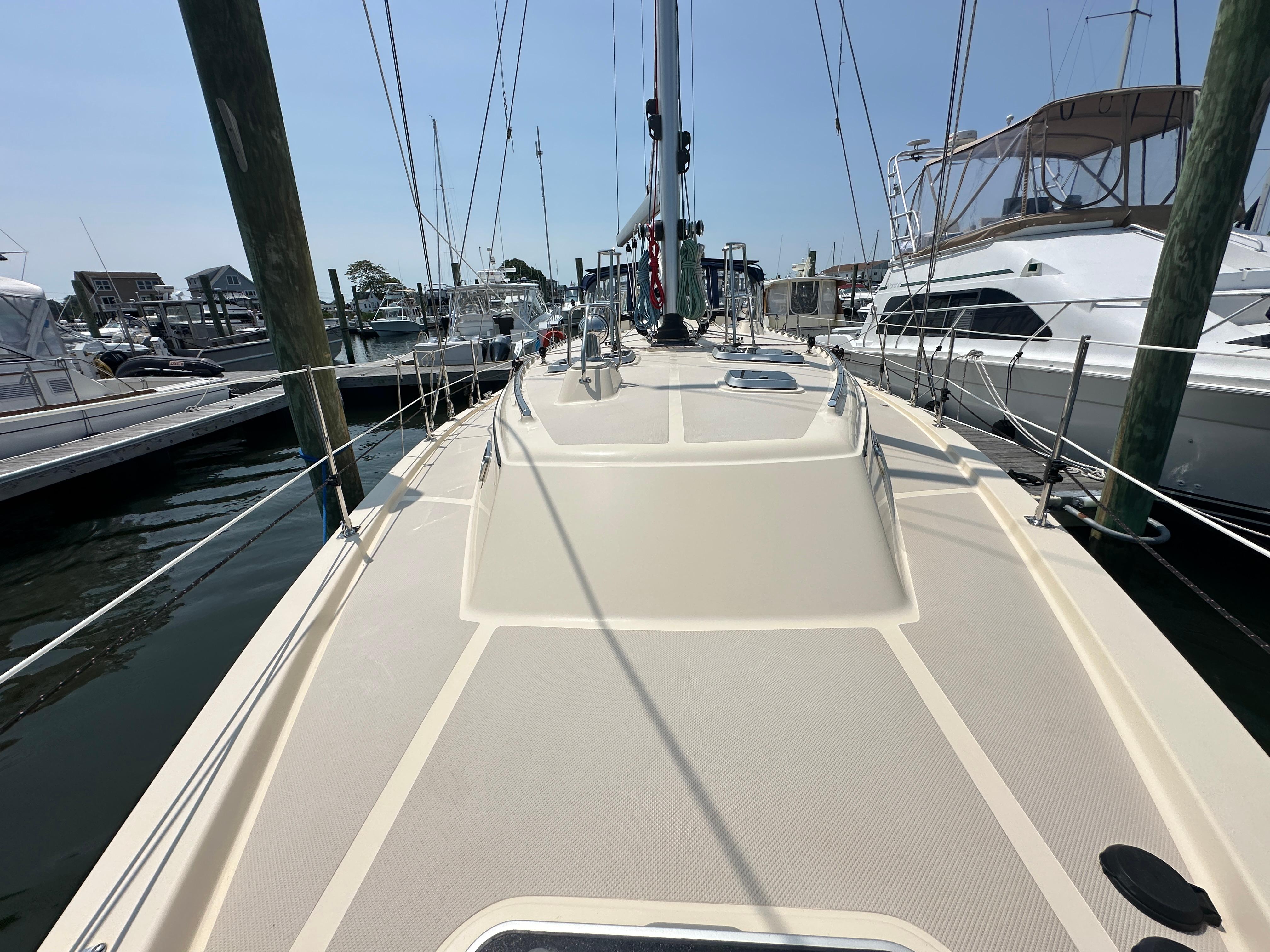 2021 Island Packet 439 sailboat docked at marina, showcasing spacious deck and rigging.