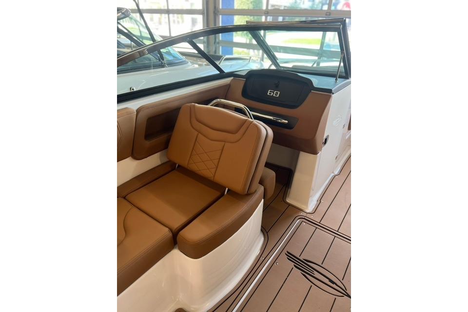 2025 Chaparral 247 SSX boat interior with brown leather seating and modern dashboard.