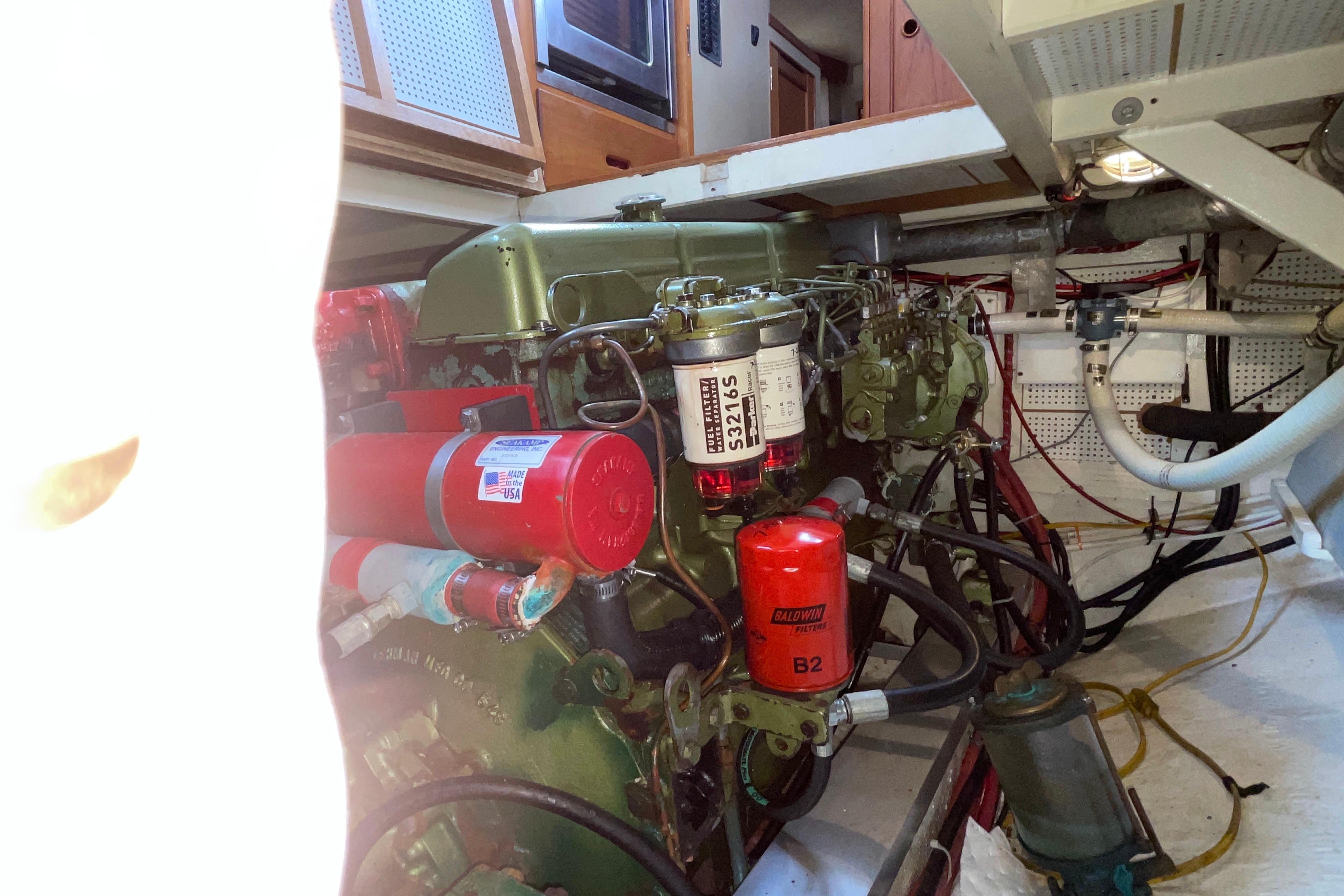 Engine room of 1982 Grand Banks 32 Sedan with visible filters and wiring.