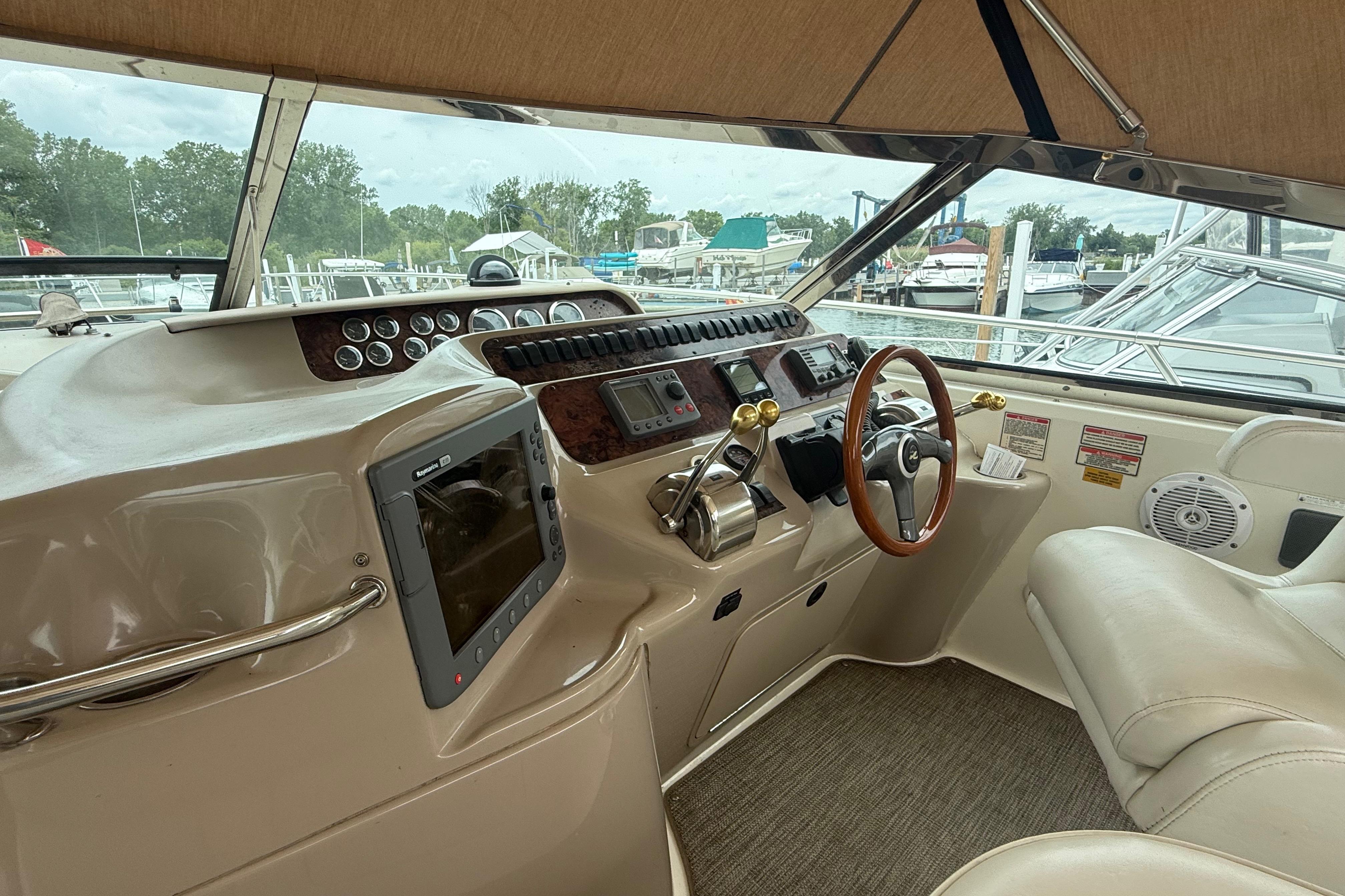 1998 Sea Ray Sundancer 400 helm with steering wheel, controls, and navigation equipment.