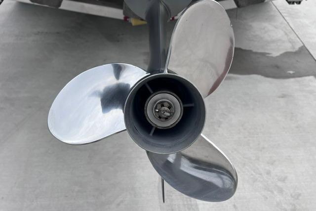 Propeller of 2021 Sportsman Tournament 234 SBX Bay Boat on concrete surface.