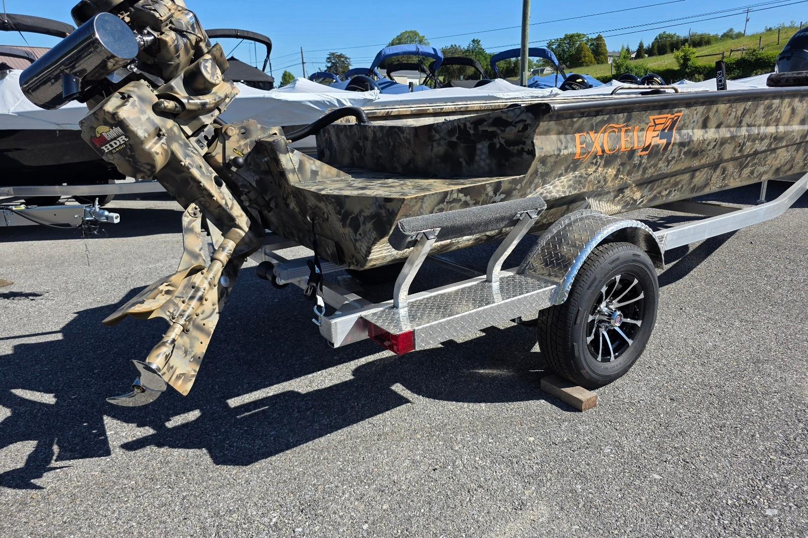 Camouflage-patterned Excel 1854 F4 boat on trailer, 2026 model, parked outdoors.