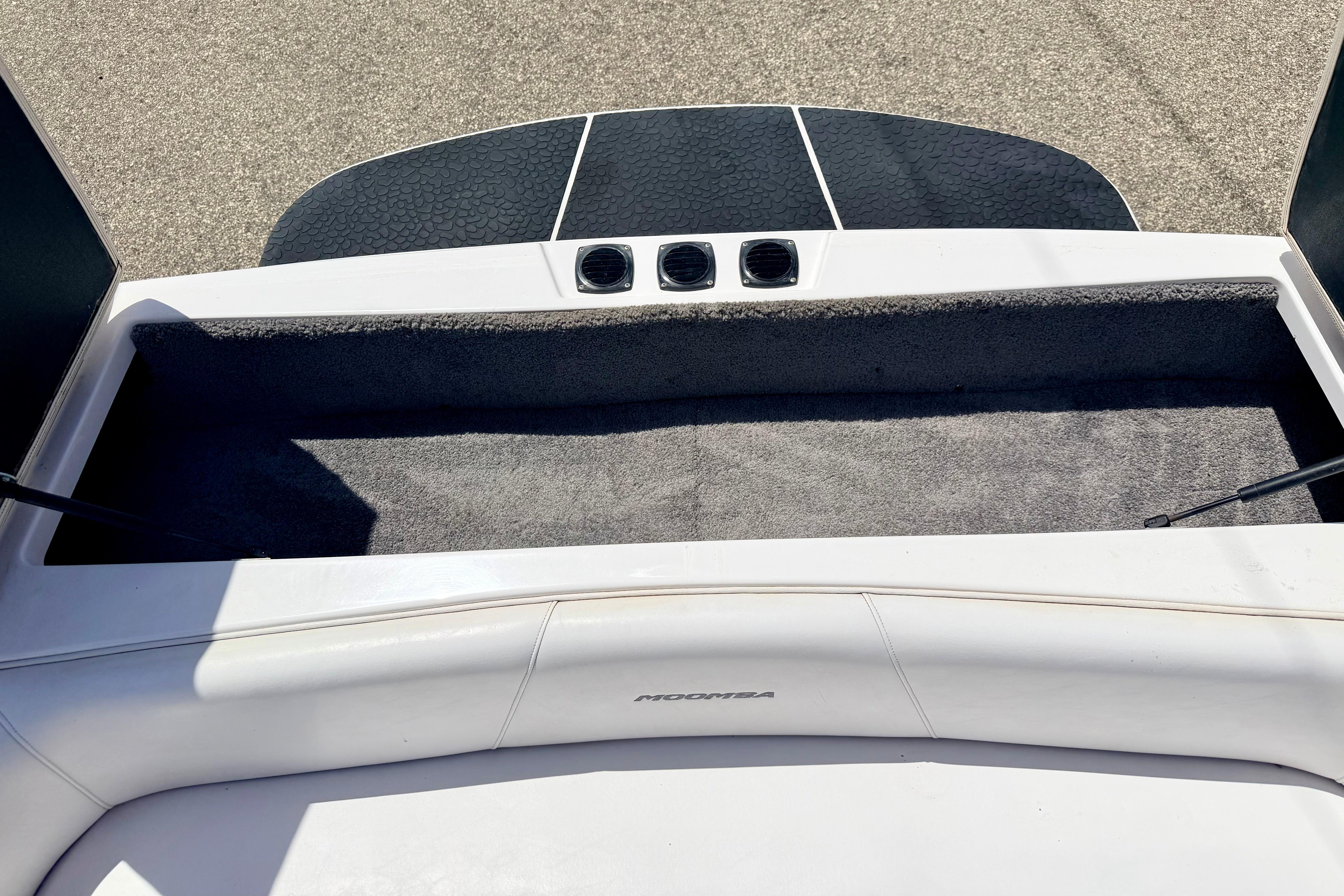 2008 Moomba Outback V boat interior with storage compartment and cushioned seating.