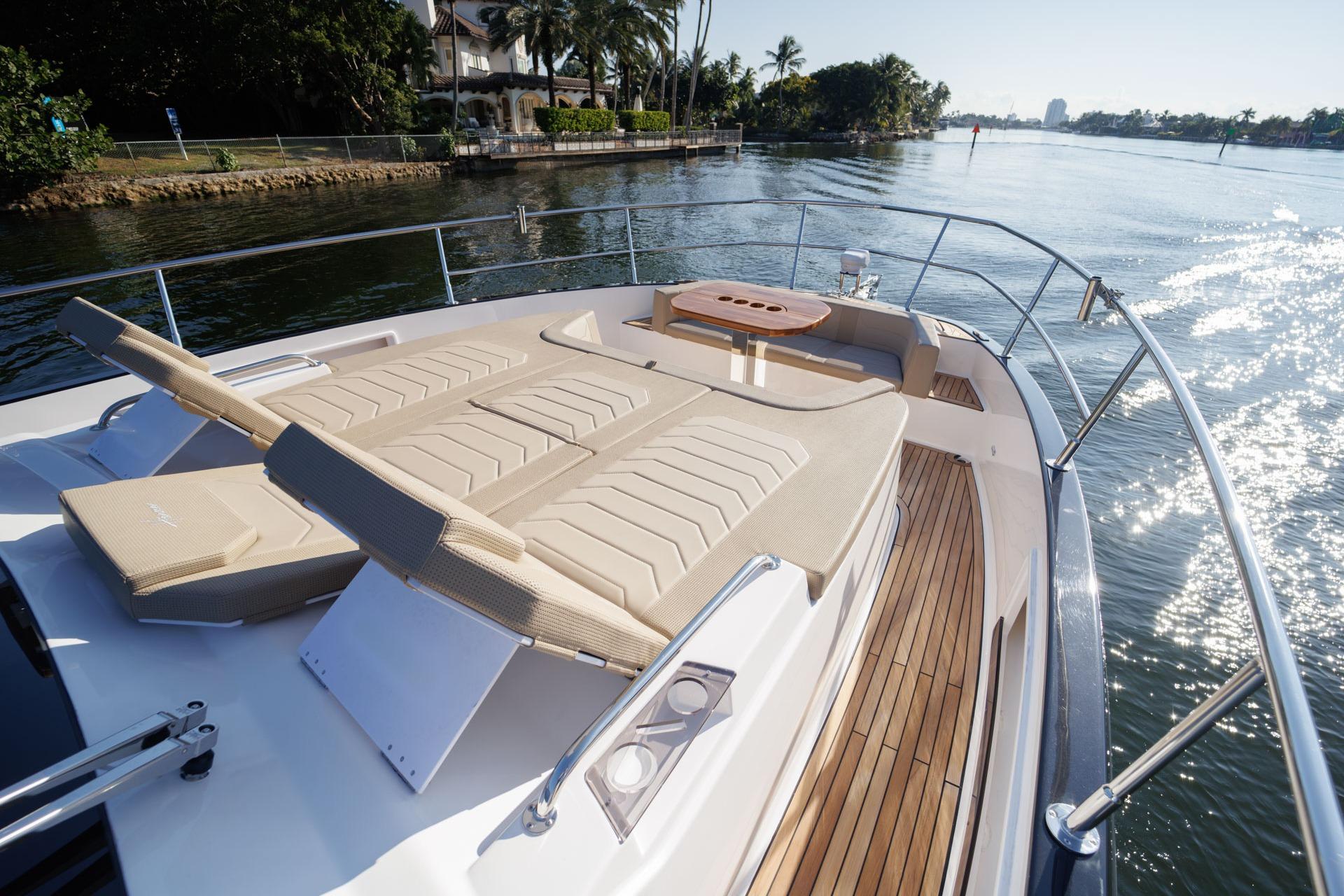 Luxurious Hanover 447 yacht deck with sun loungers, cruising on a sunny day, 2026 model.