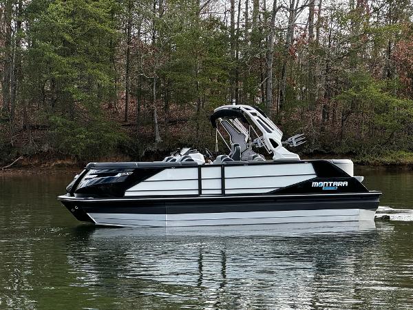 2025 Montara Surf Boss 2.0 25 boat on a calm lake with forested background.
