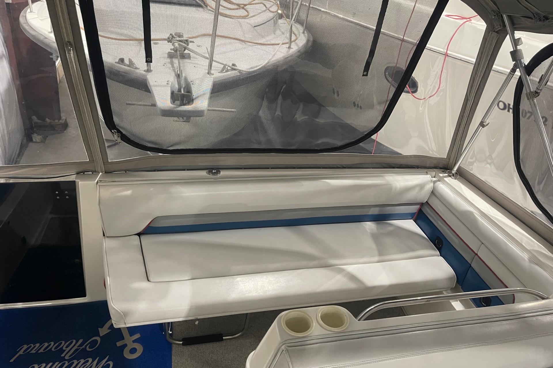 1992 Chaparral Signature 30 boat interior with white seating and clear canopy.