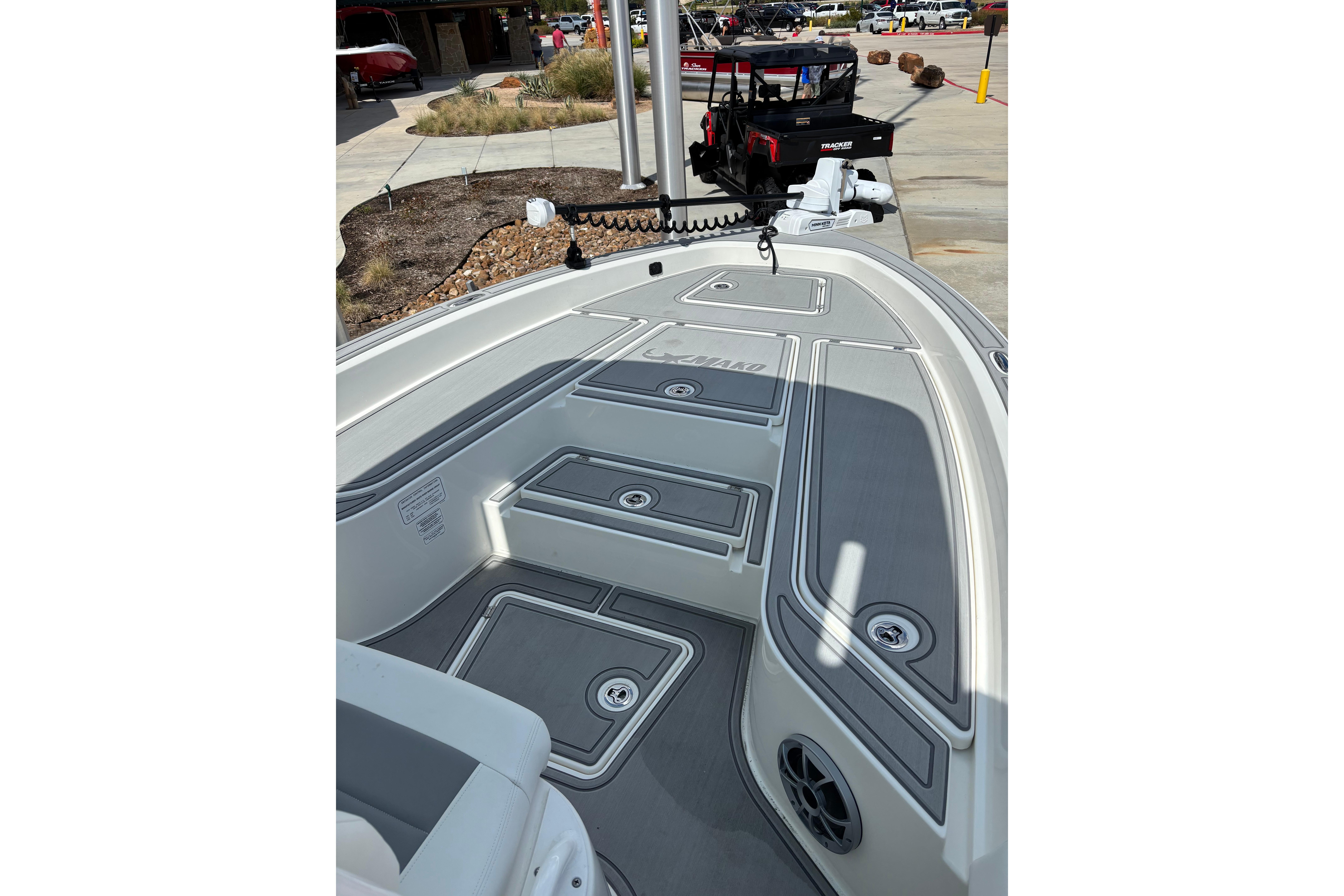 2026 Mako 24 APEX boat deck with storage compartments and sleek design.