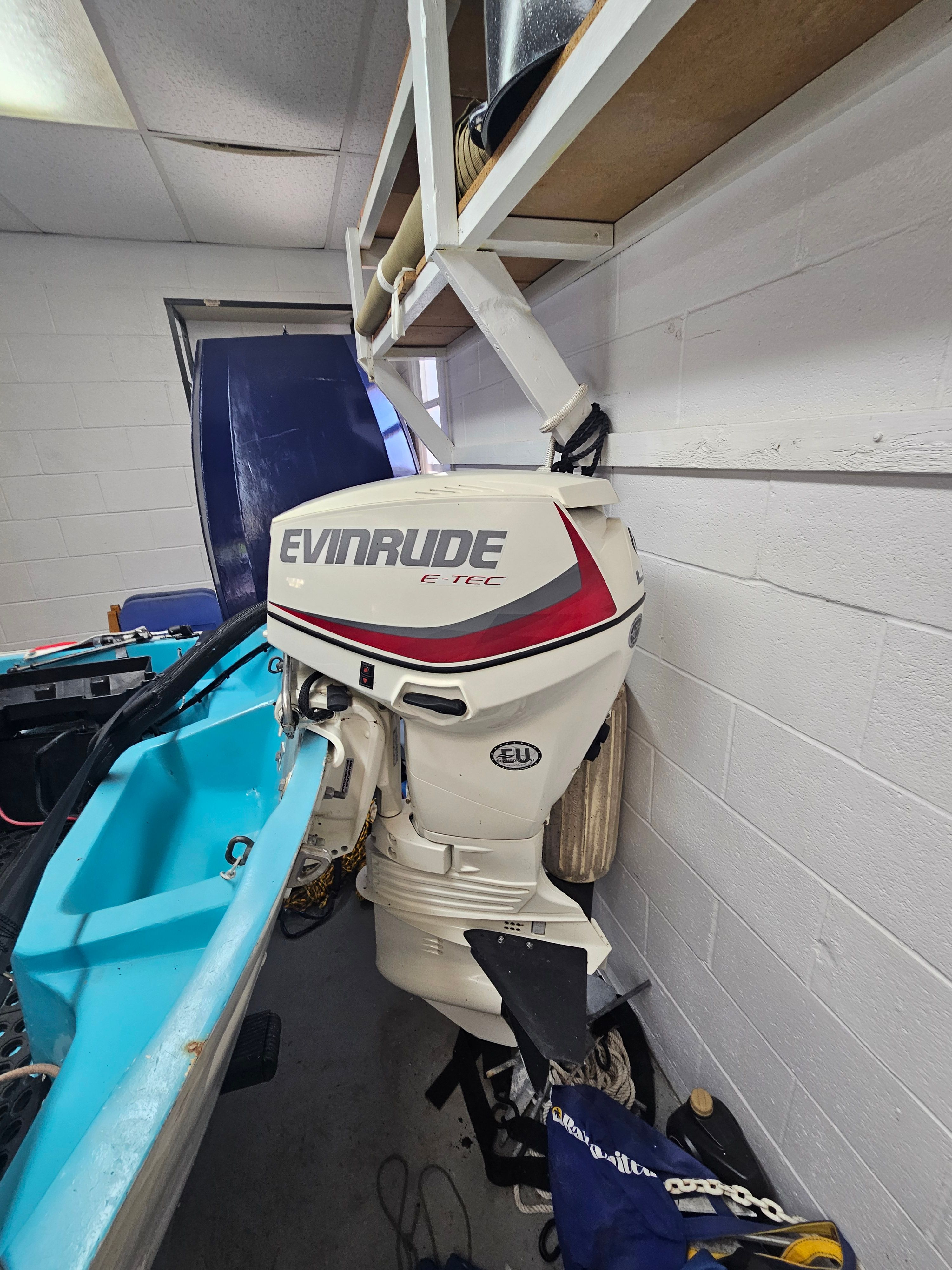 1977 Boston Whaler 14 with Evinrude motor in garage.