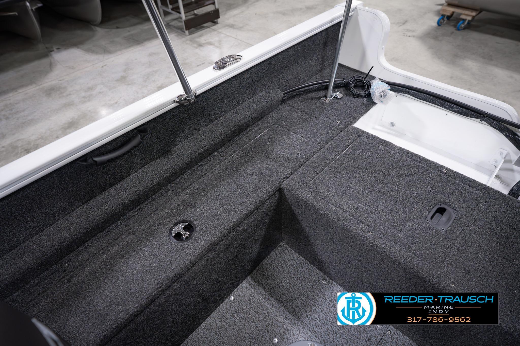 Interior view of 2026 Lund 1650 Rebel XL SS boat, featuring carpeted flooring and storage compartments.