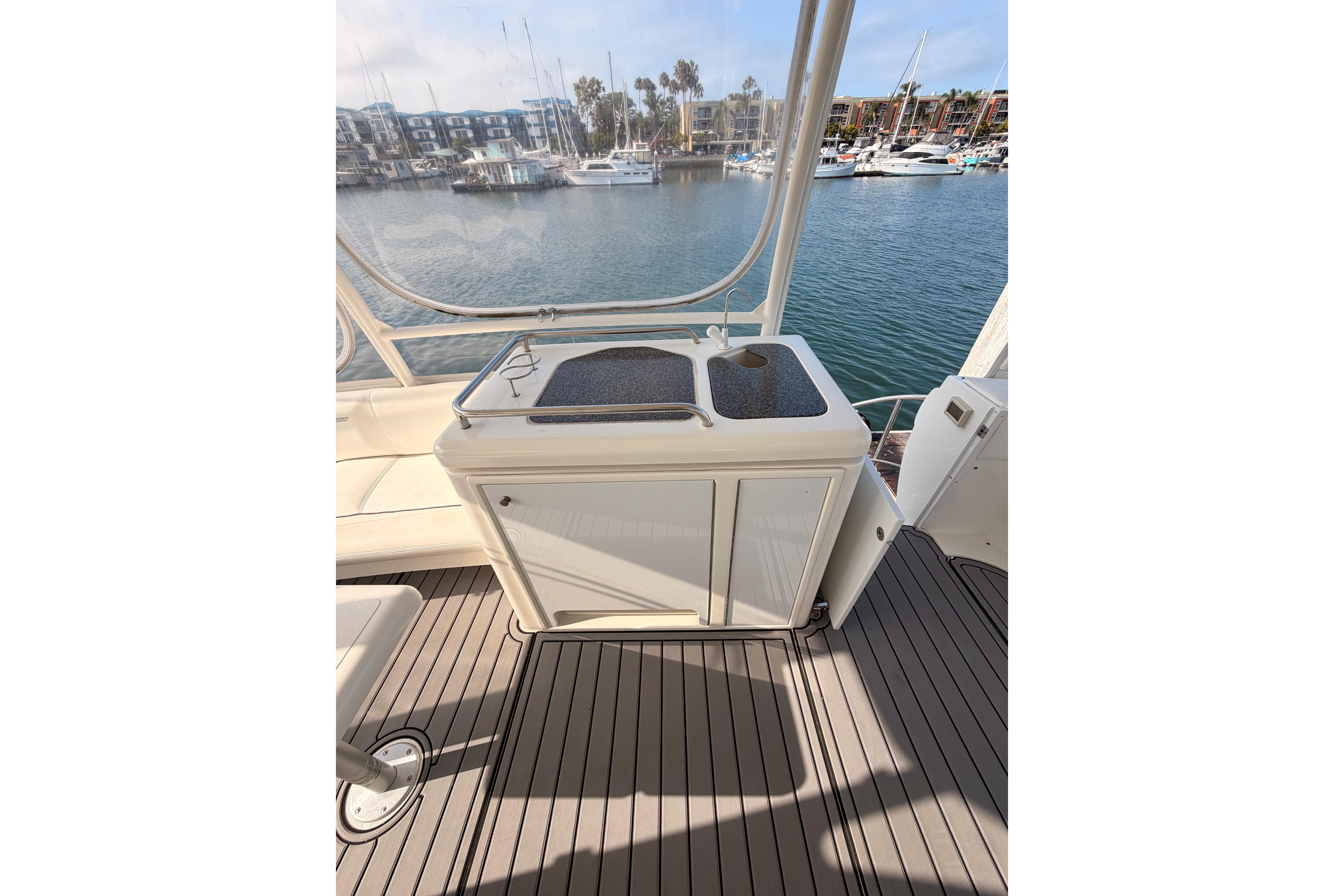 2005 Cruisers Yachts 405 Express Motoryacht deck with sink, overlooking marina.