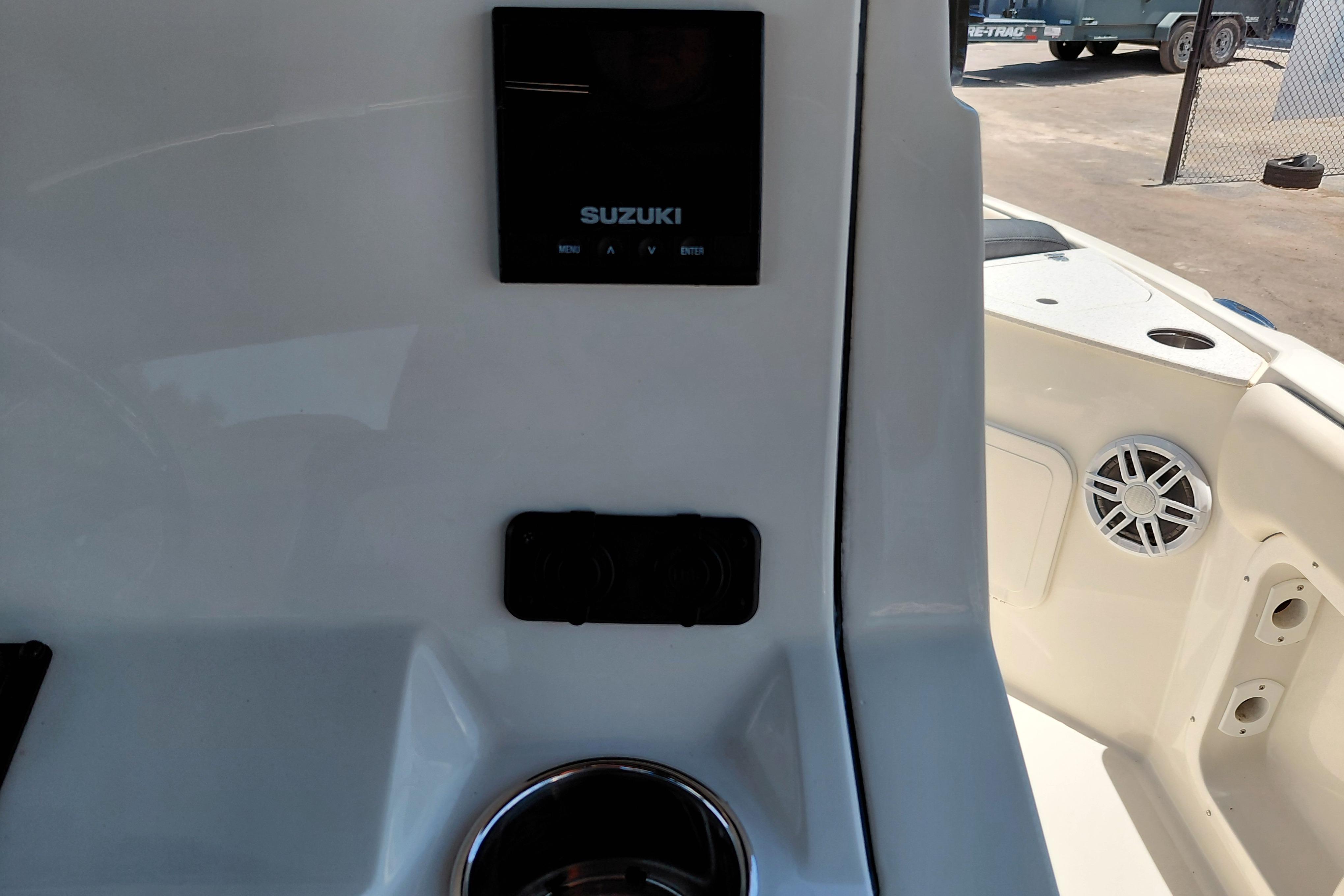 2023 Stingray 206 CC boat dashboard with Suzuki display and speaker.