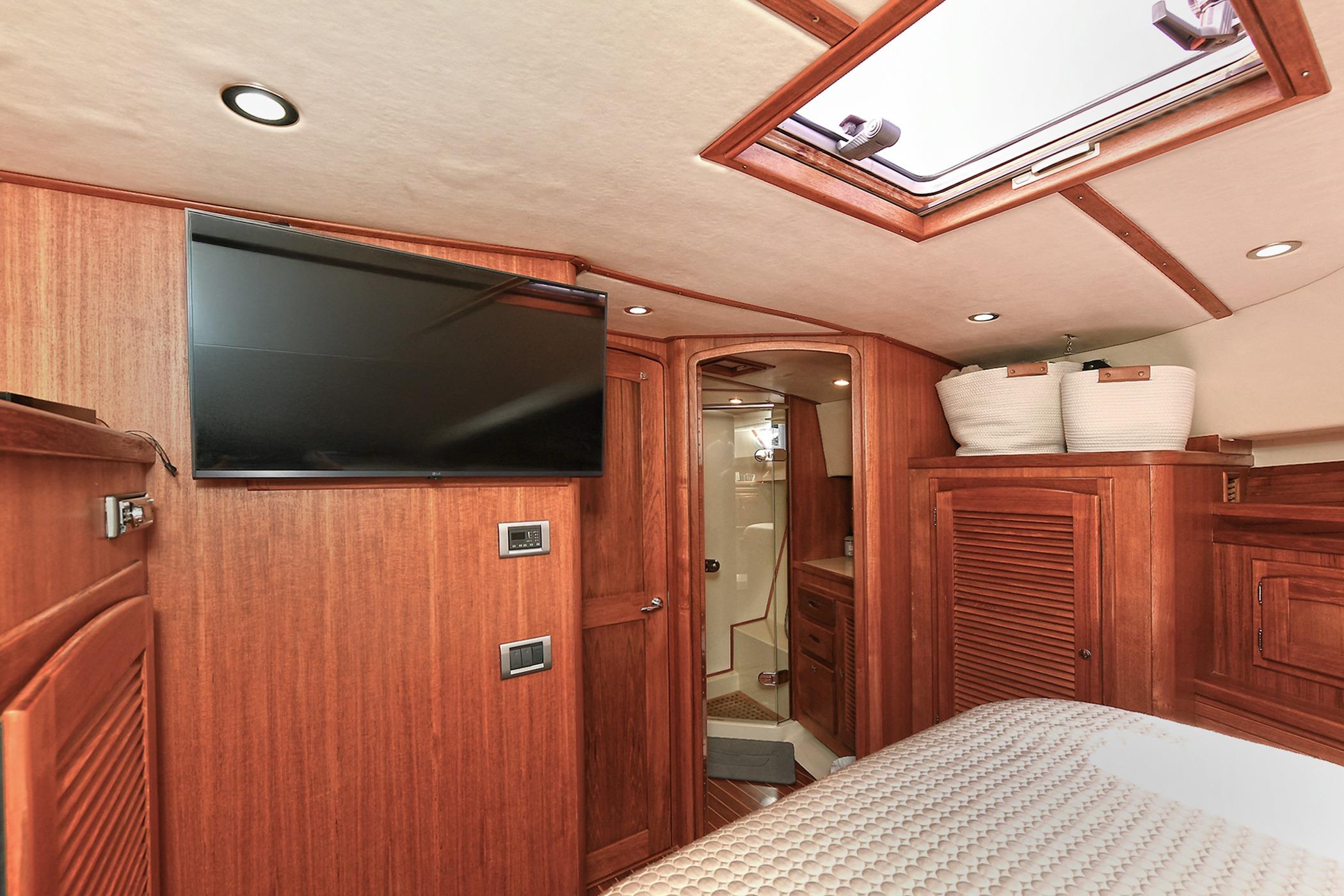 Luxurious 2005 San Juan Downeast Express cabin interior with wood finish and modern amenities.