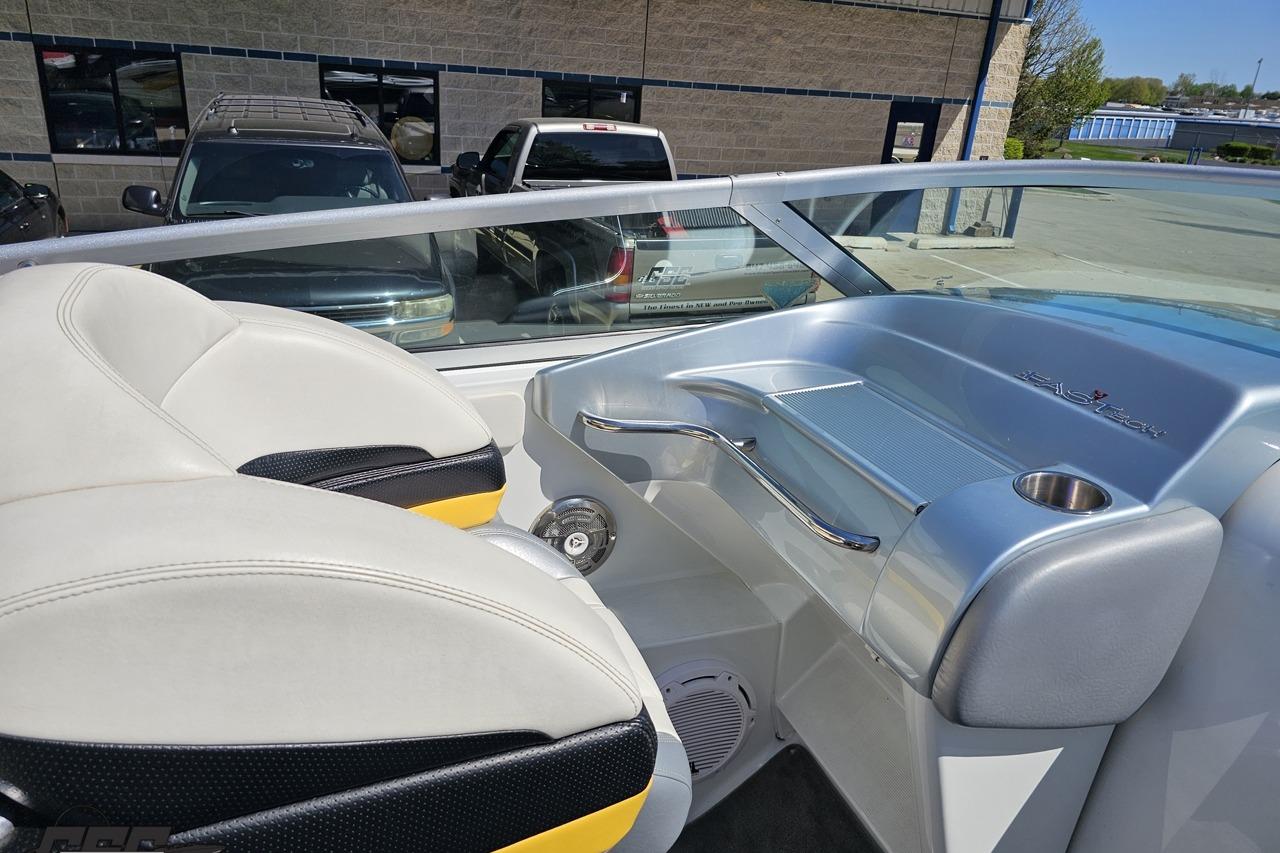 2014 Formula 292 FASTech boat interior with white and yellow seating, cup holder, and dashboard.
