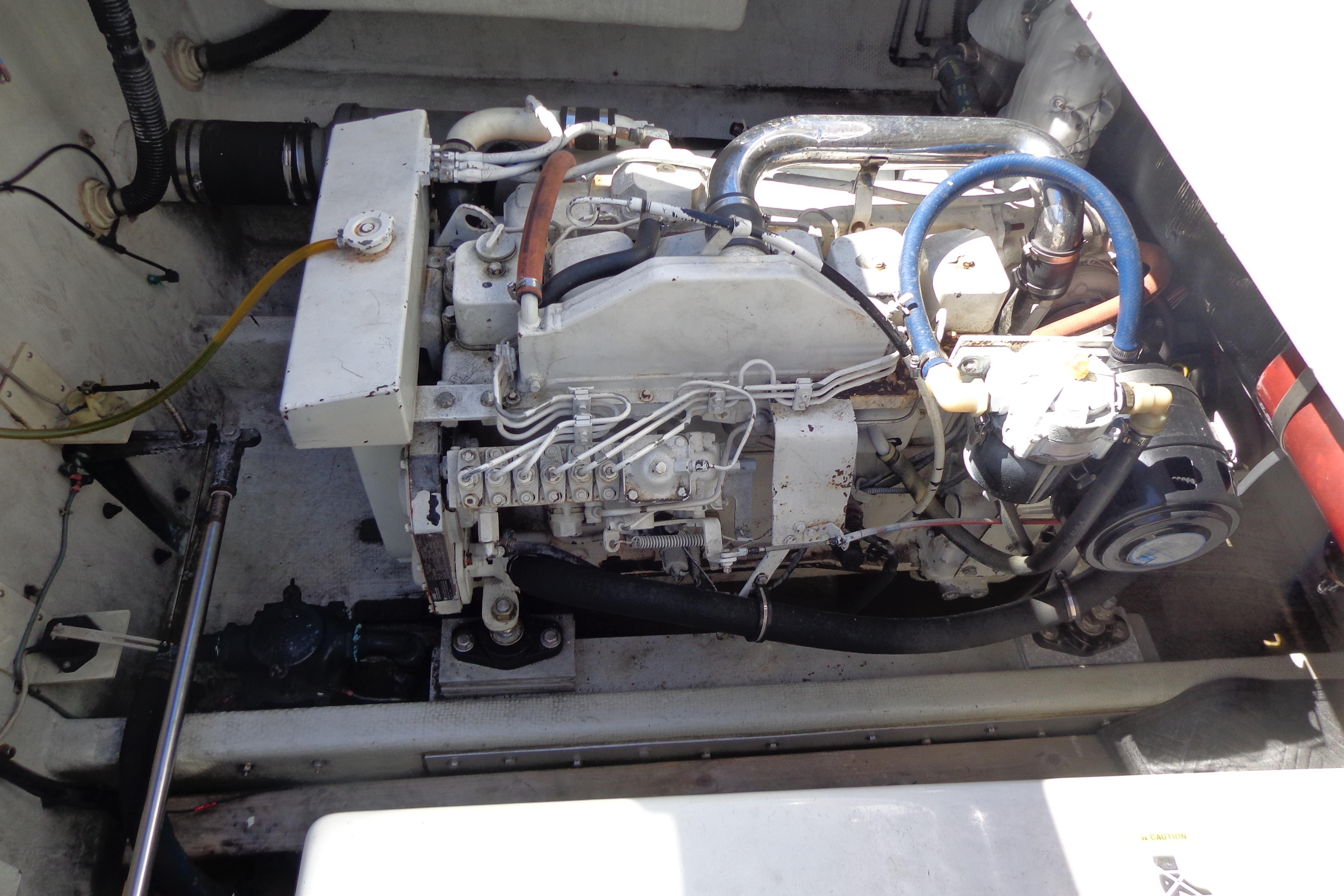 Engine compartment of a 1992 Cruise-A-Home Corsair 4200 boat, showcasing mechanical components.