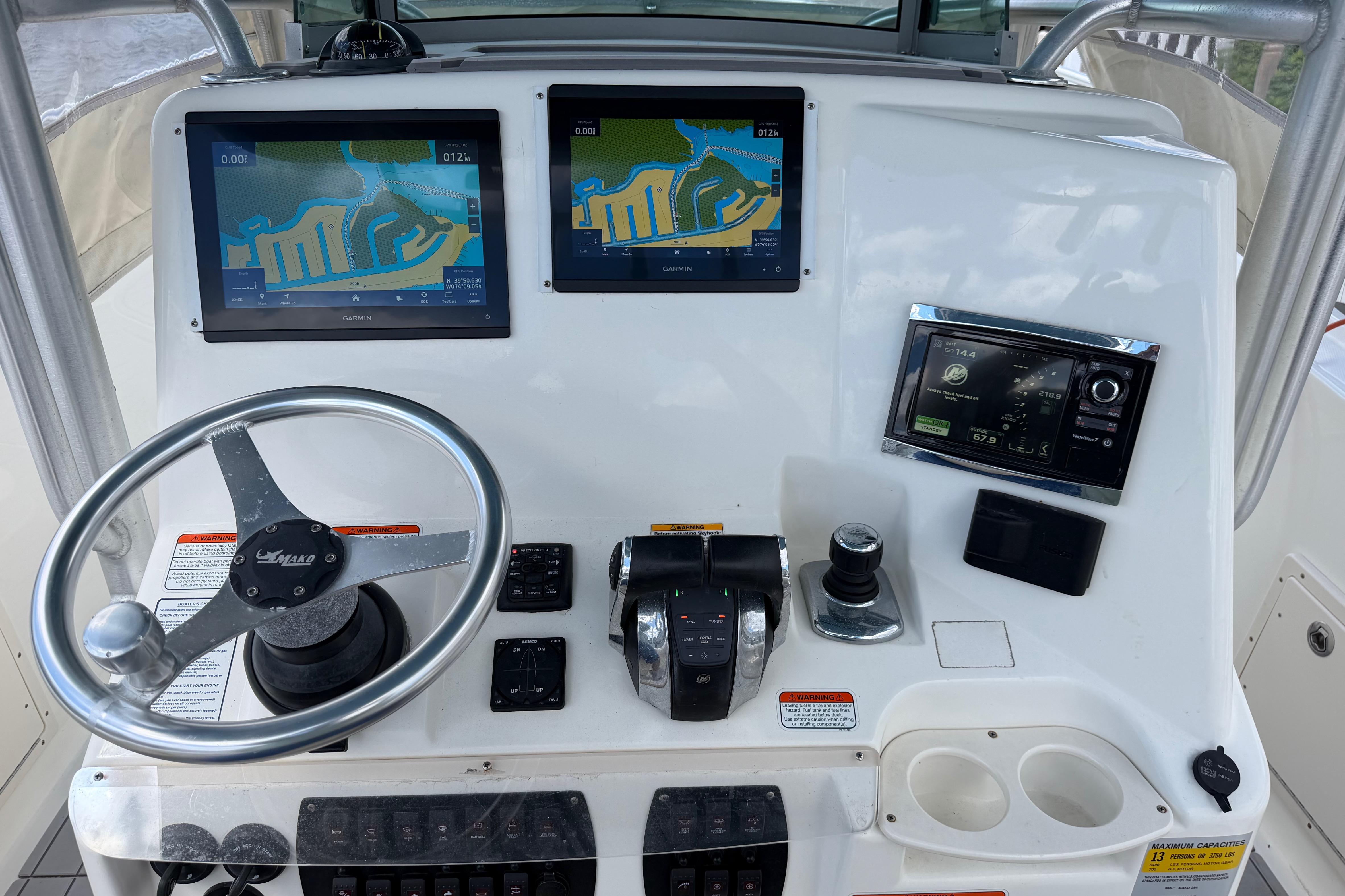 2017 Mako 284 Center Console boat dashboard with navigation screens and controls.