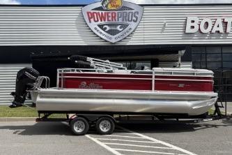 2026 Sun Tracker SportFish 20 DLX pontoon boat on trailer outside dealership.