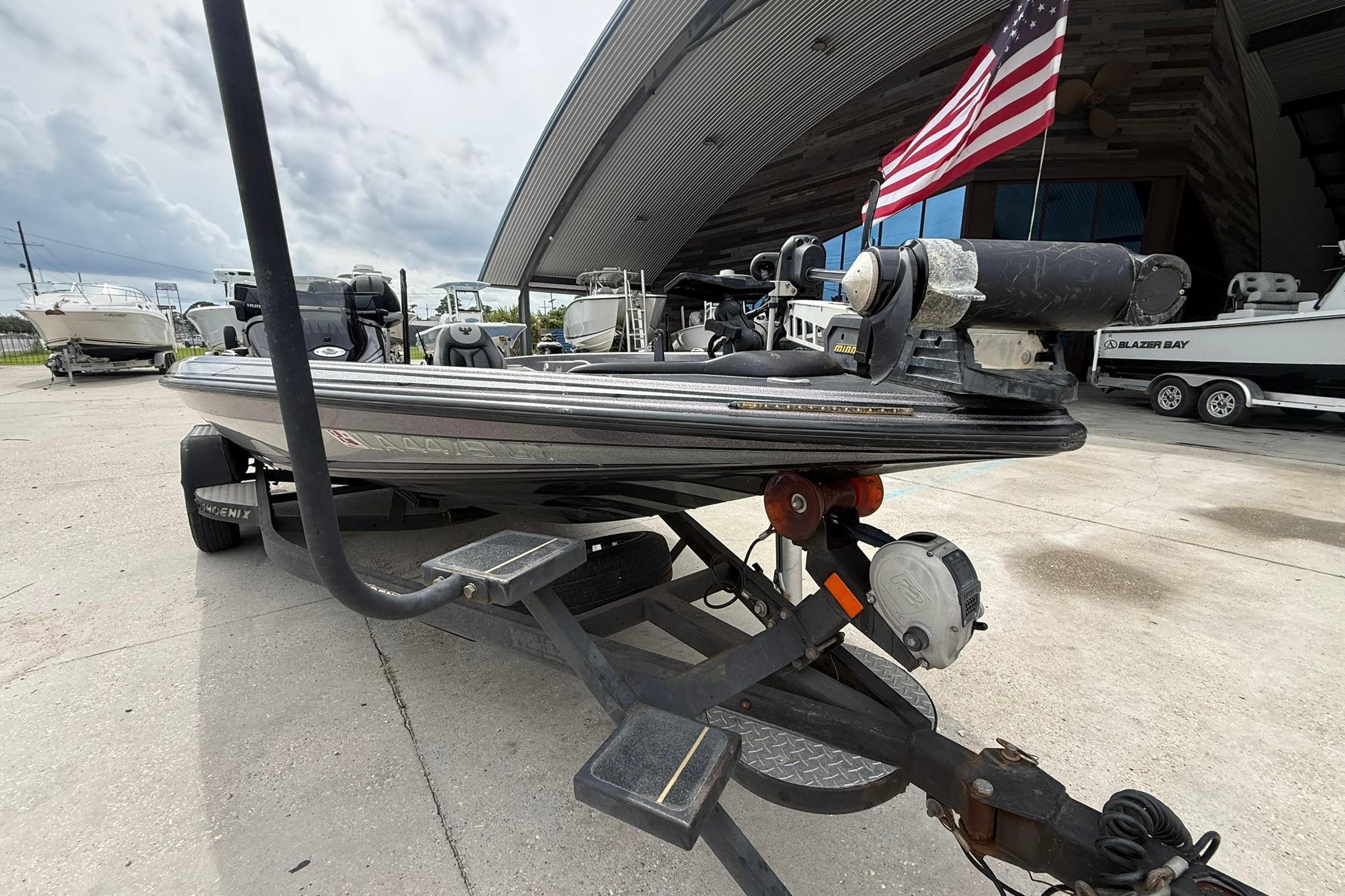 2018 Phoenix 919 ProXP boat on trailer, American flag, outdoor setting.