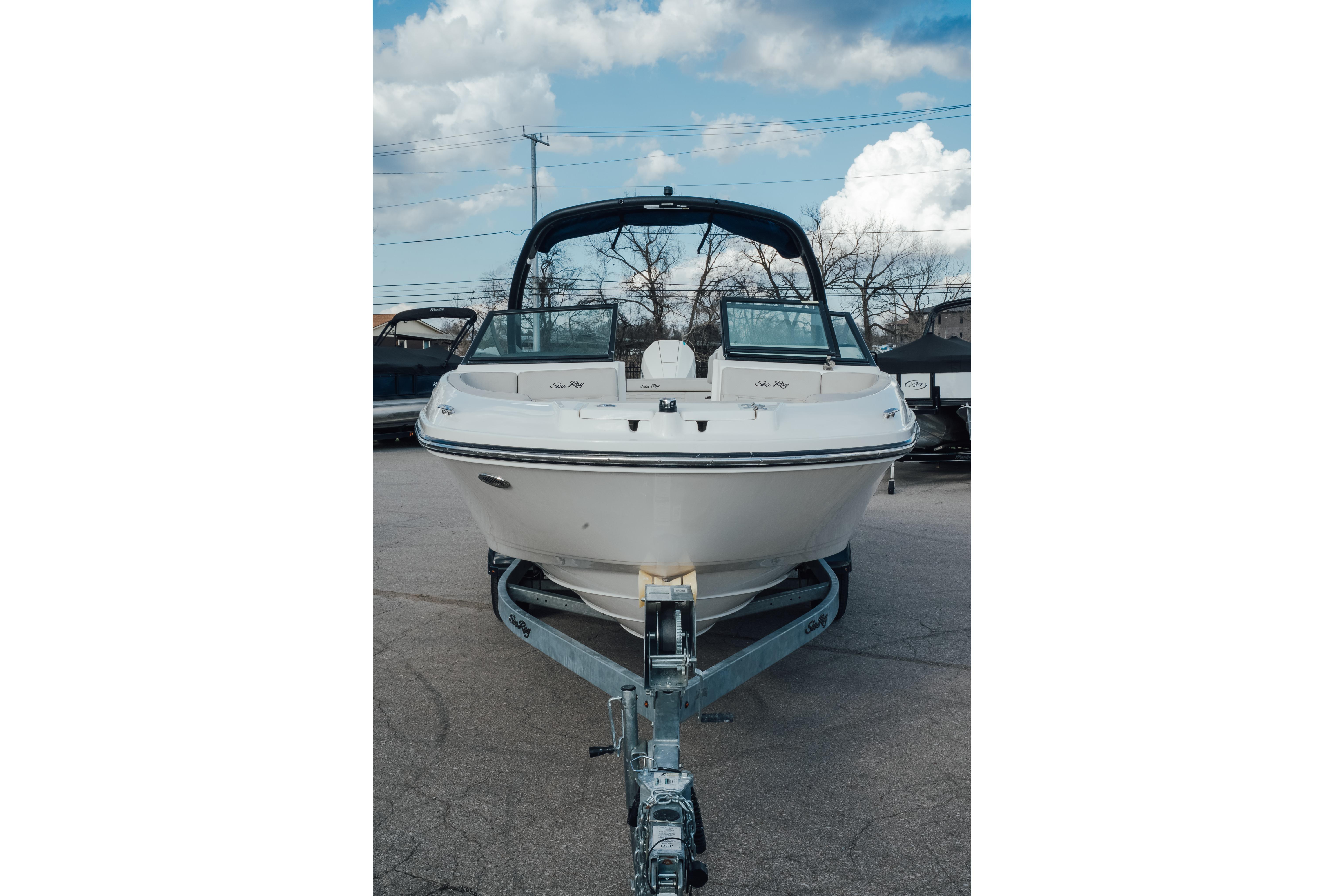 2023 Sea Ray SPX 230 Outboard boat on trailer, front view under cloudy sky.
