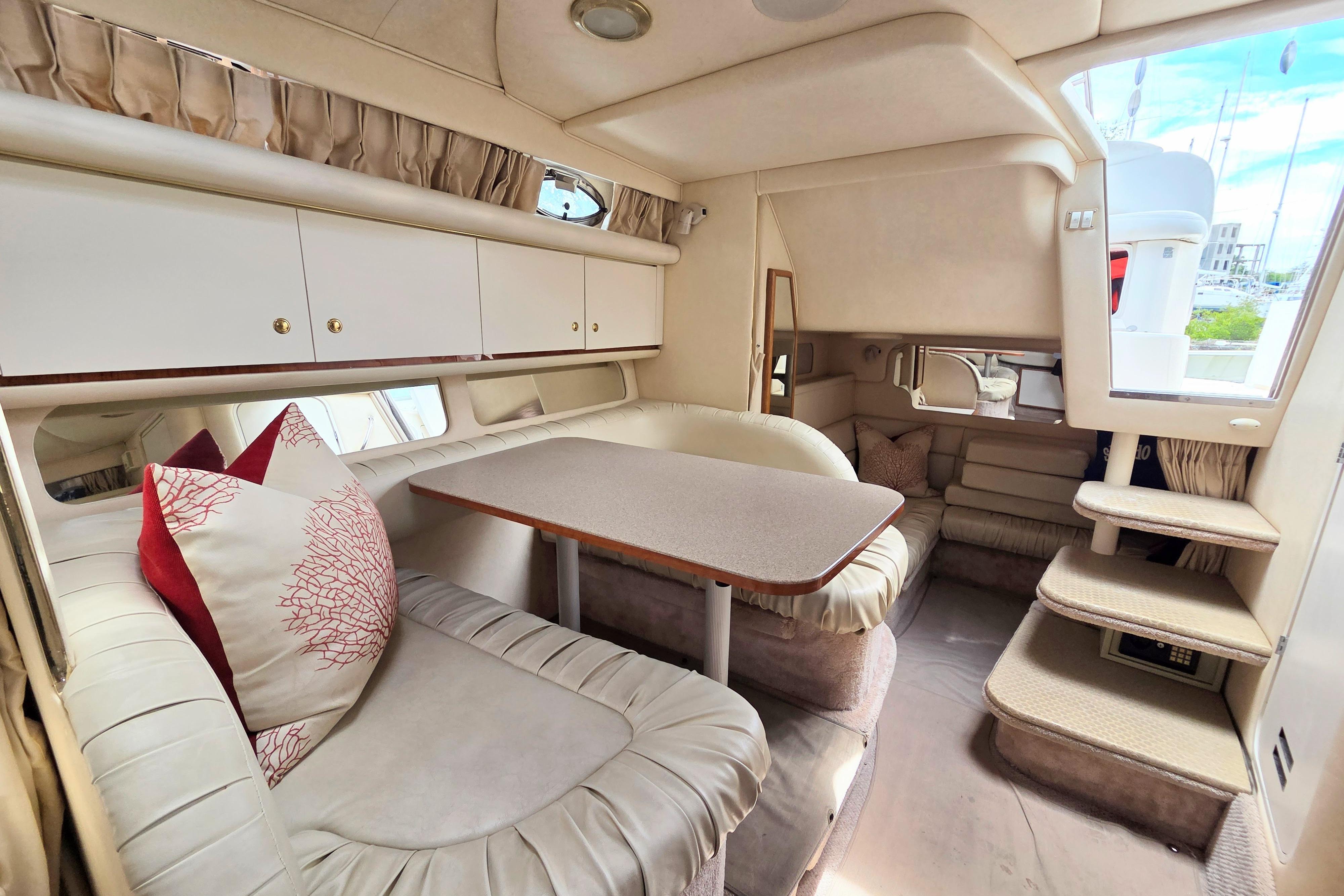 Interior of 2000 Sea Ray 340 Sundancer yacht with cozy seating and dining area.