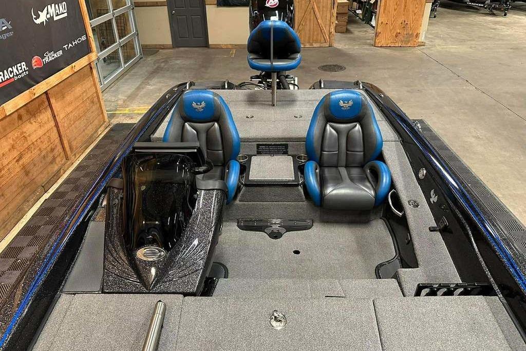 2017 Phoenix 919 ProXP boat interior with blue and gray seating in a showroom.