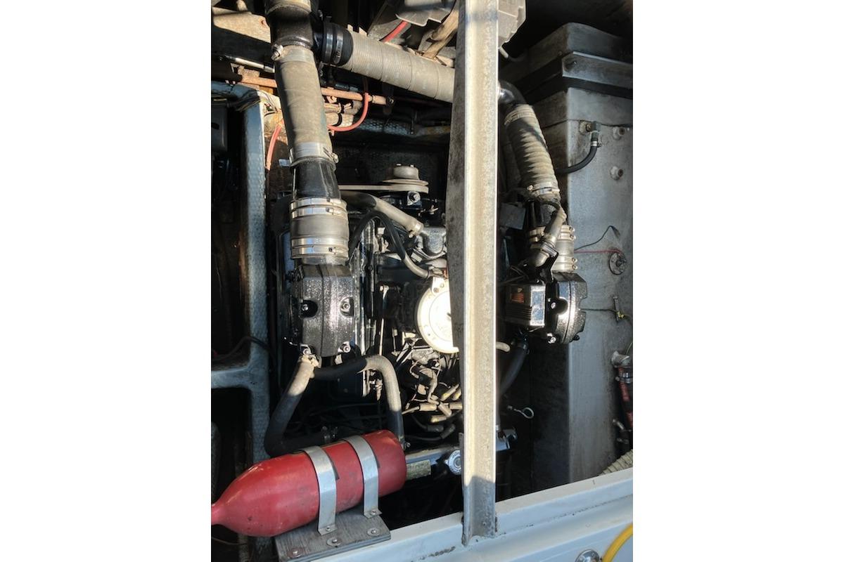 Engine compartment of a 1986 Carver Mariner 28 boat, showing mechanical components.