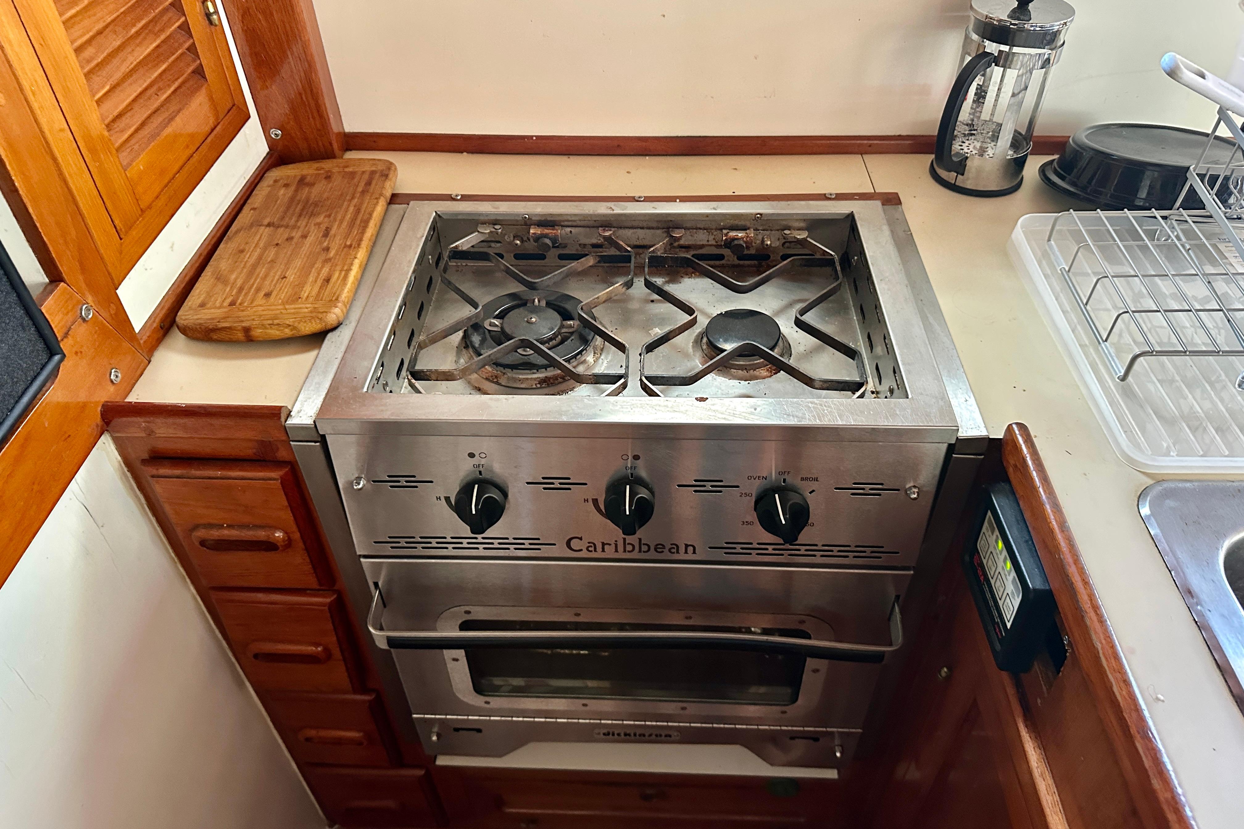 Galley stove in 1983 Kadey-Krogen Krogen 42 Trawler, featuring wooden cabinetry and countertop.