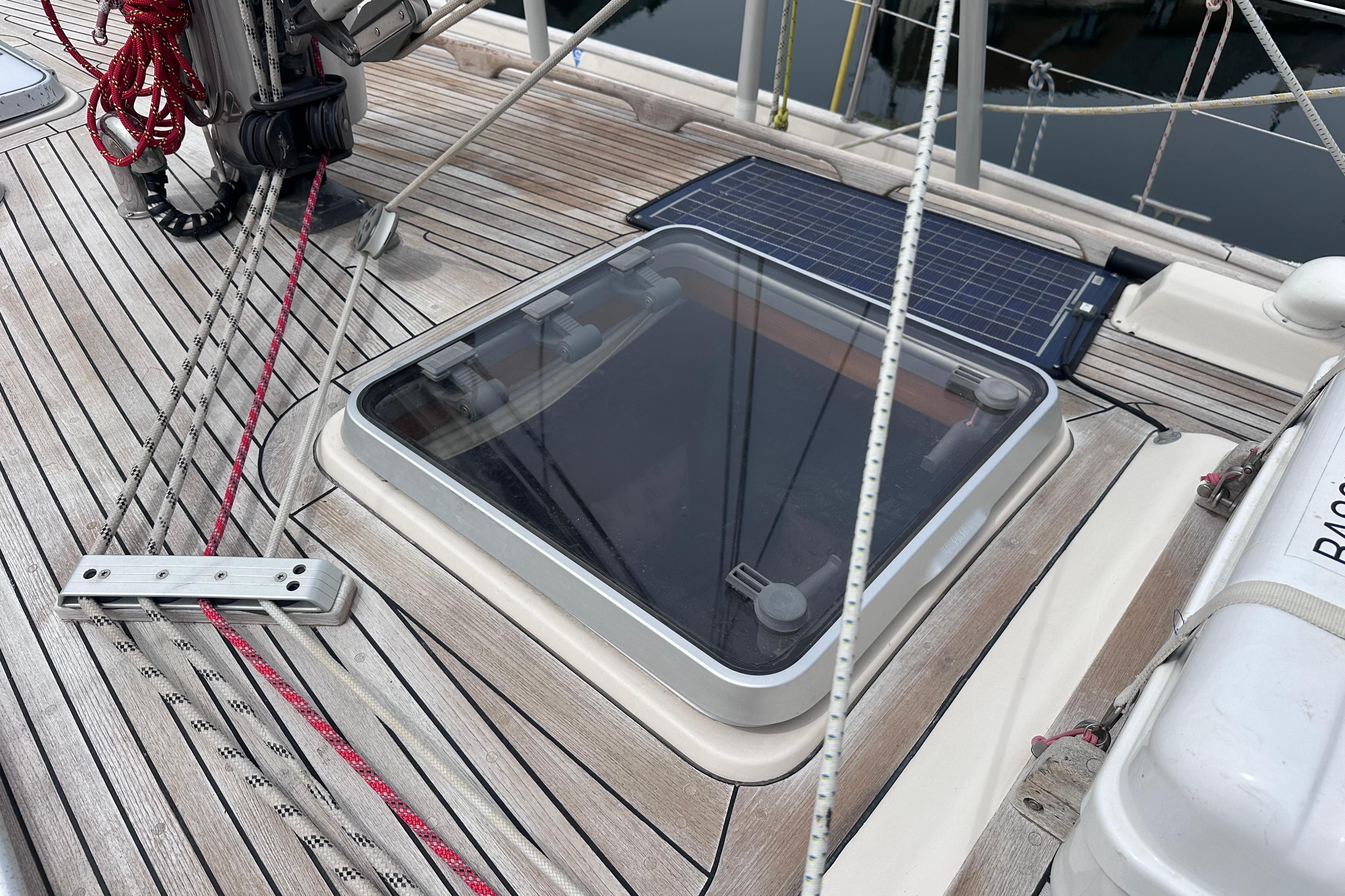 Deck of 1999 Hallberg-Rassy 39 sailboat with hatch and solar panel.