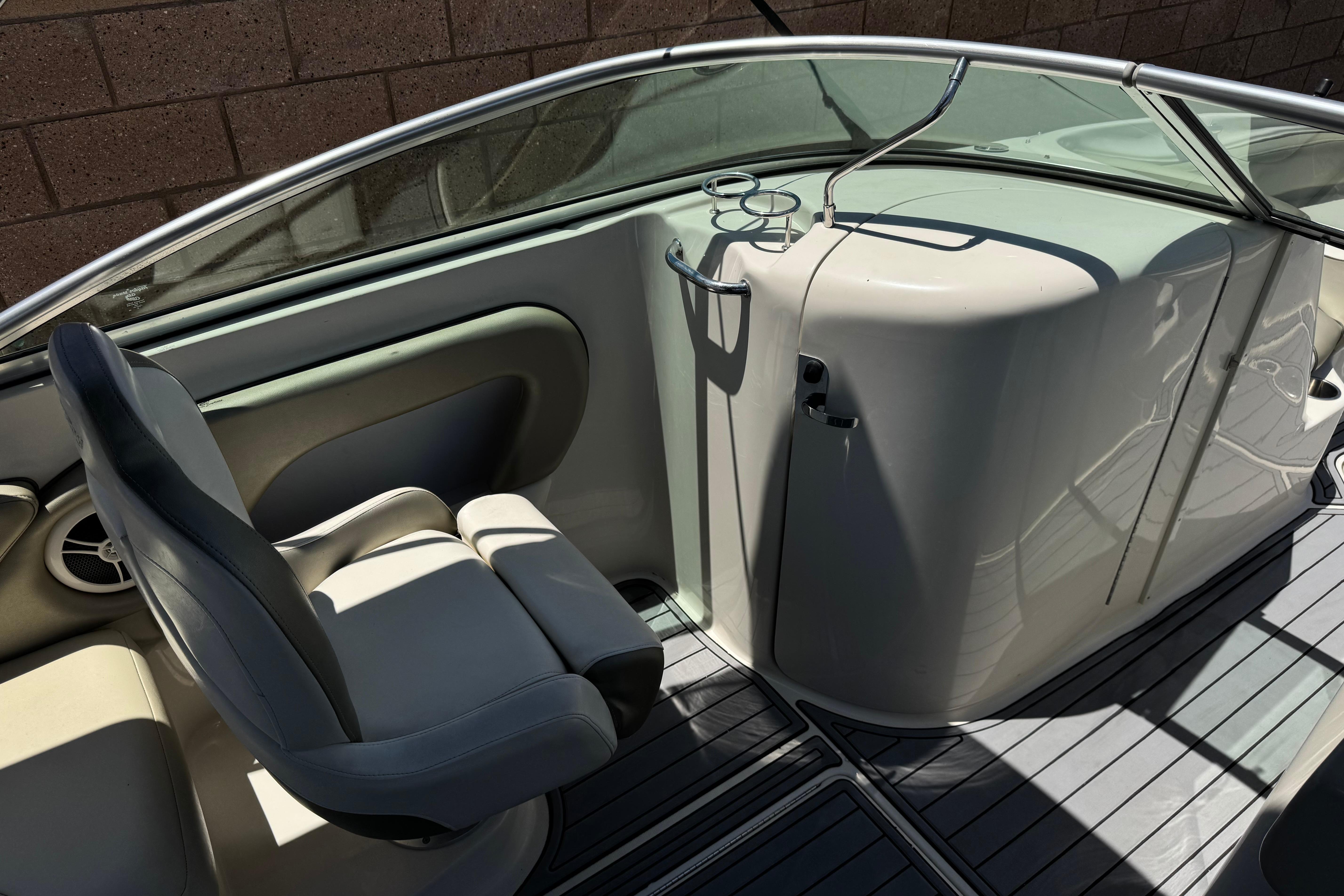 2007 Sea Ray 240 Sundeck interior with seating and cup holders, showcasing sleek design.