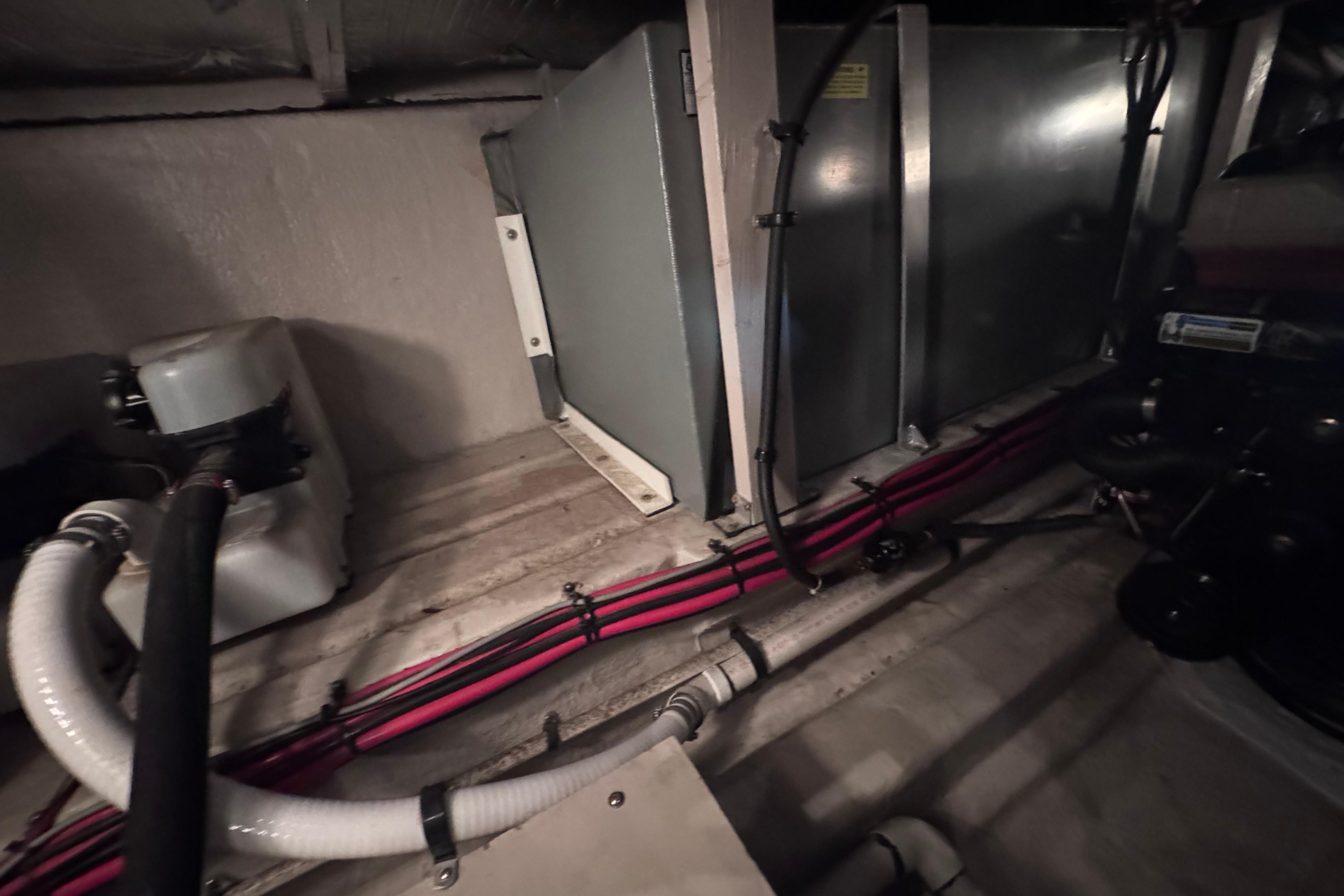 Engine room of a 2004 Sea Ray 390 Motor Yacht with visible piping and machinery.