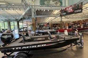 2026 Tracker Panfish 17 boat displayed in a showroom with other boats.