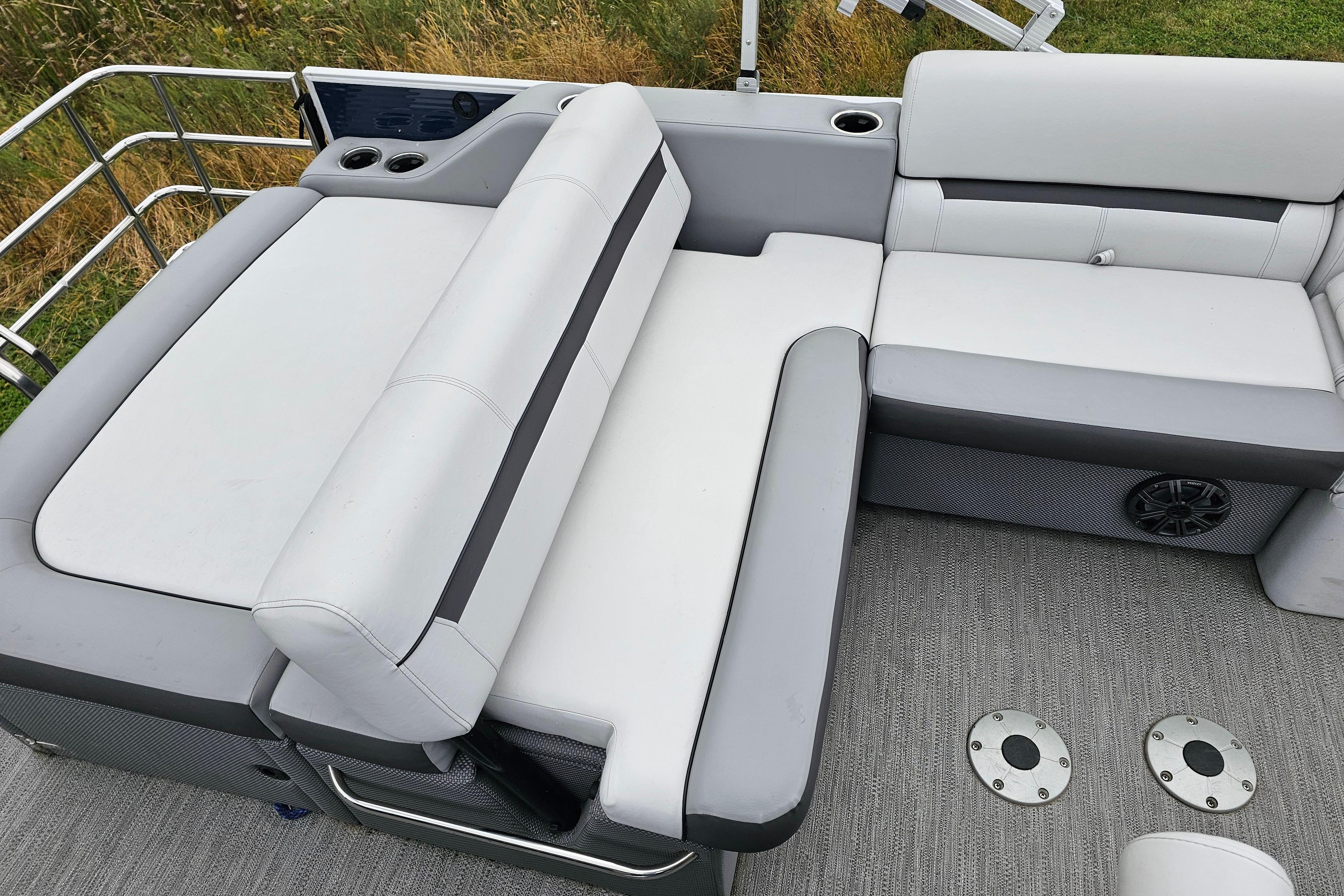 2022 Sweetwater 2286 SFL boat interior with gray and white cushioned seating.