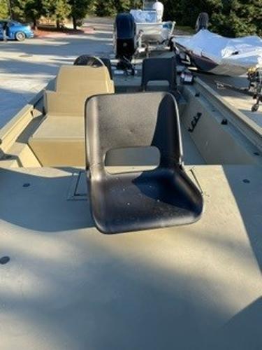 2024 Tracker Grizzly 1754 SC boat with black seat, outdoor setting.