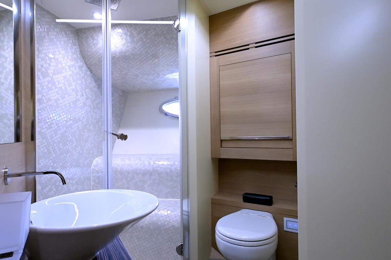 Luxurious bathroom interior of 2015 Pershing 92 yacht with modern fixtures and elegant design.