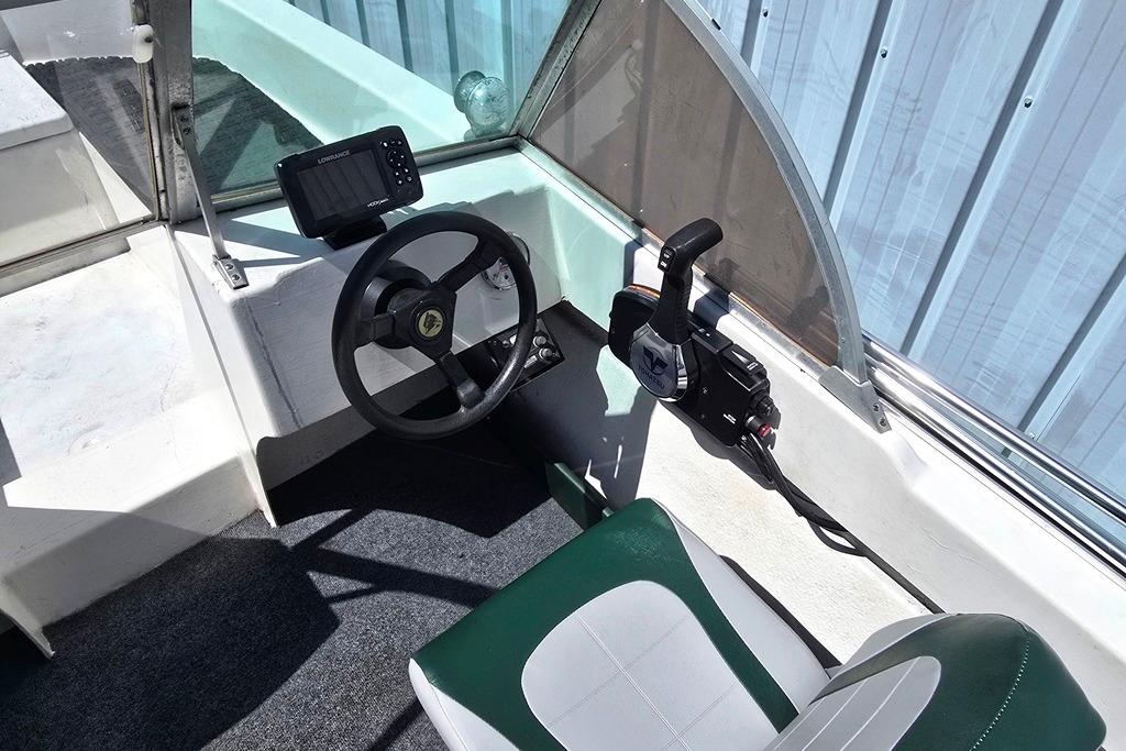 1971 Jupiter 15' Tri Hull boat interior with steering wheel and control panel.