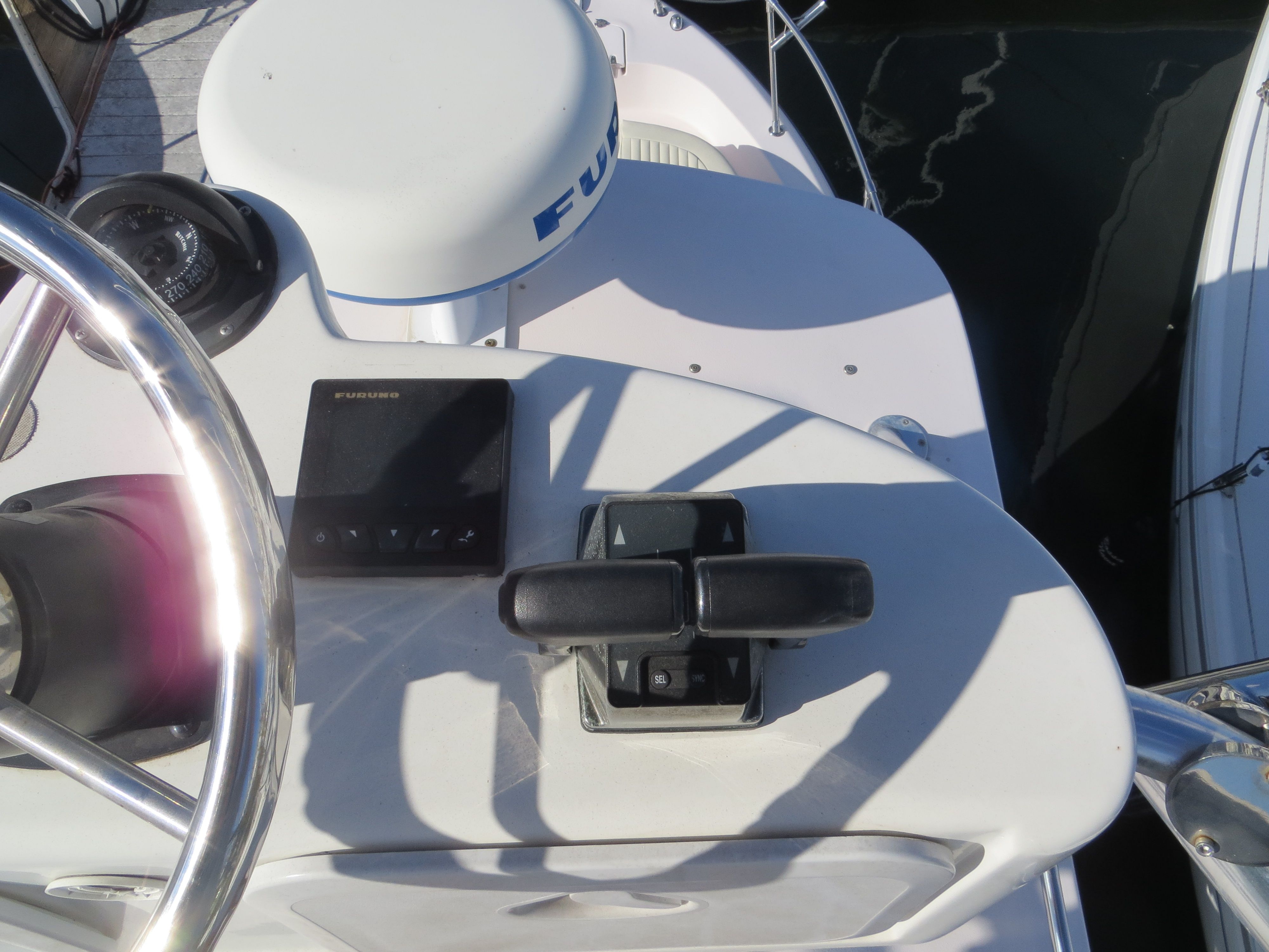 Helm of a Grady-White Sailfish 282 with controls and electronics.