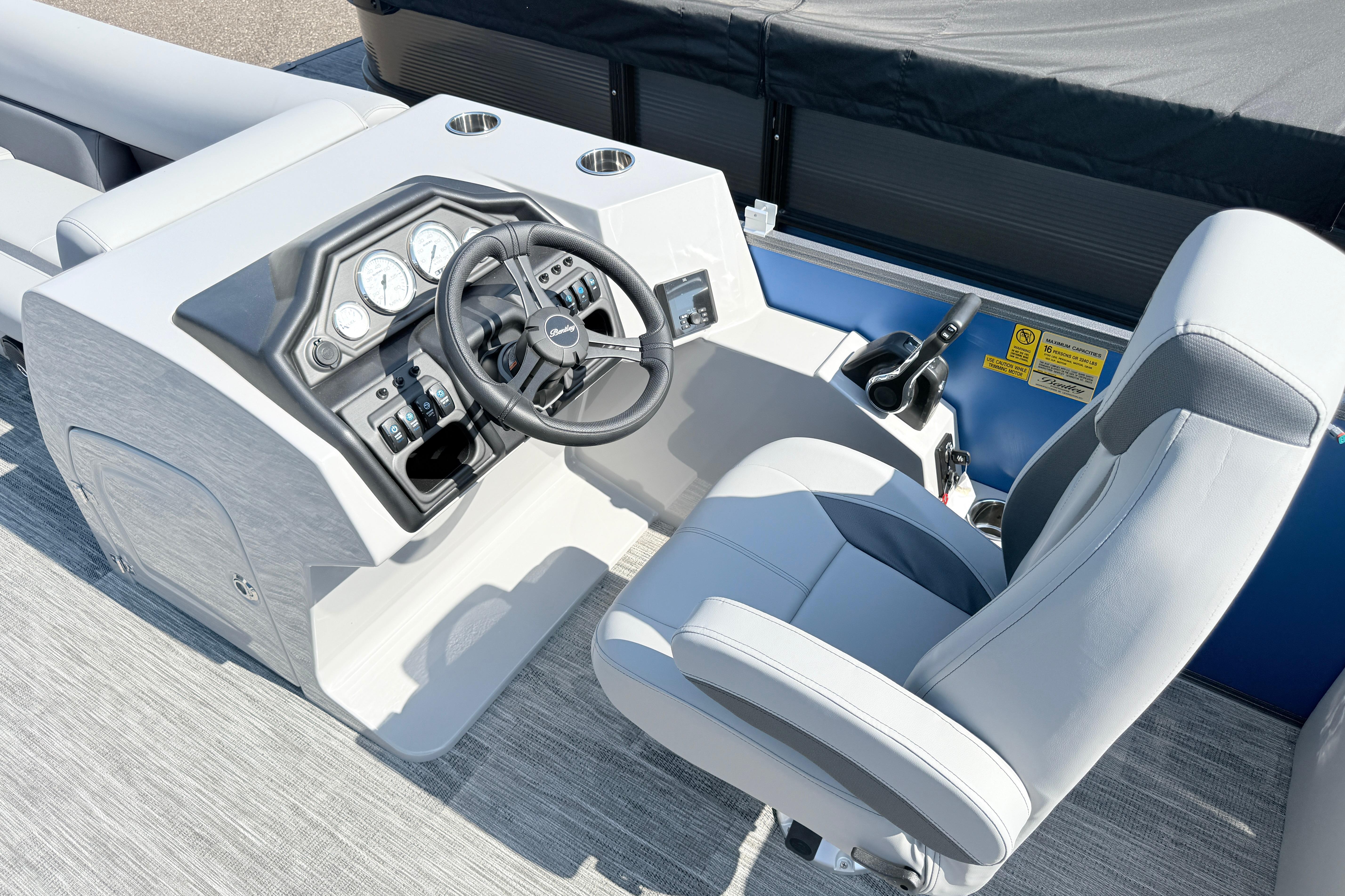 2027 Bentley Pontoons Legacy 240 Navigator helm with modern controls and comfortable captain's chair.