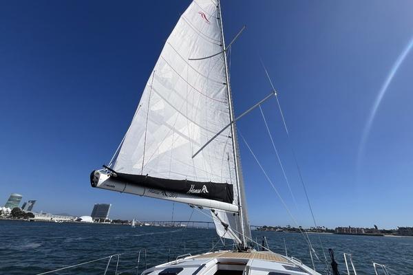 2025 Hanse 360 sailboat on open water with clear blue sky.