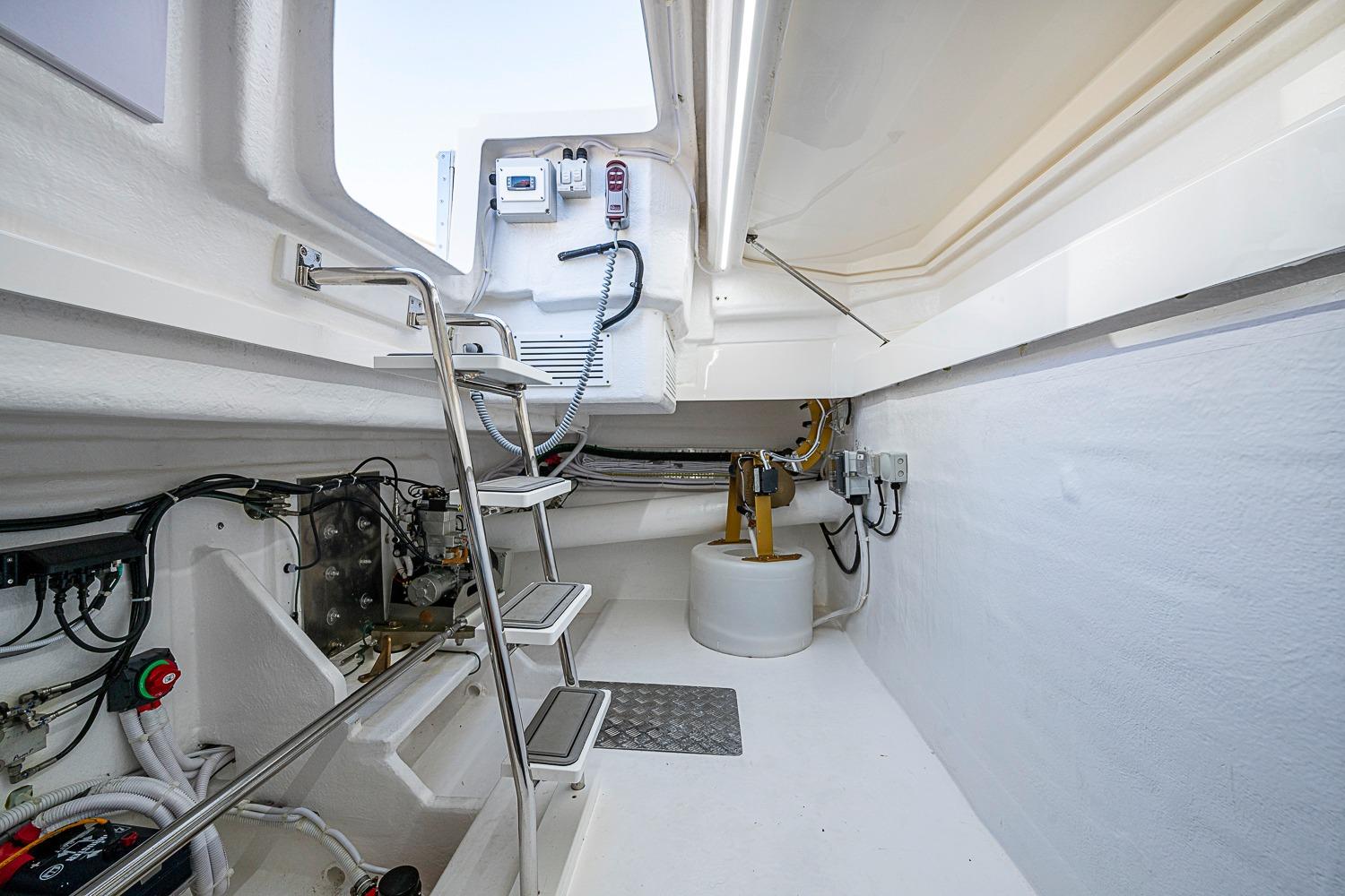 Engine room of 2026 Maritimo M50 yacht with ladder and equipment.