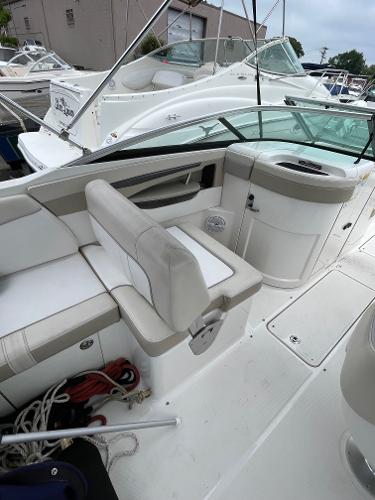 2013 Sea Ray 240 Sundeck boat interior with white seating and storage compartments.
