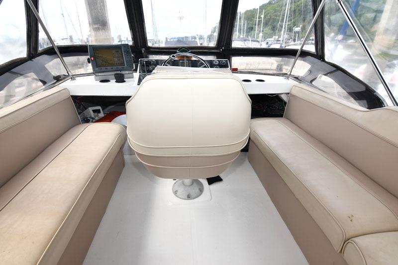 Interior view of 1990 Bayliner 3288 Motoryacht cockpit with seating and navigation equipment.
