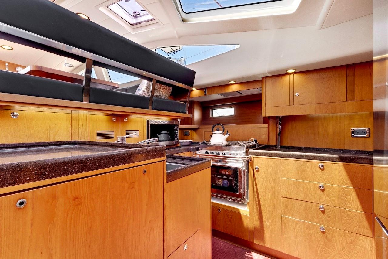 Luxurious interior of 2011 Southerly 57 RS yacht with modern kitchen amenities.