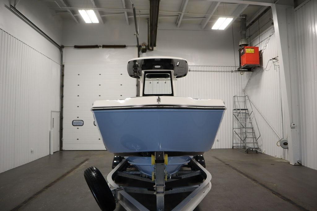 2026 Yamaha Boats 255 FSH Sport E in a spacious indoor facility.