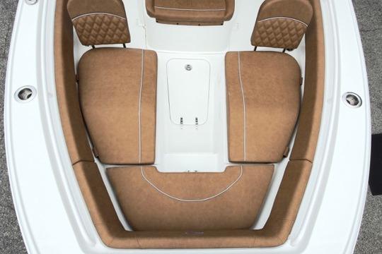 2026 Sea Hunt Ultra 255 SE boat interior with brown cushioned seating.