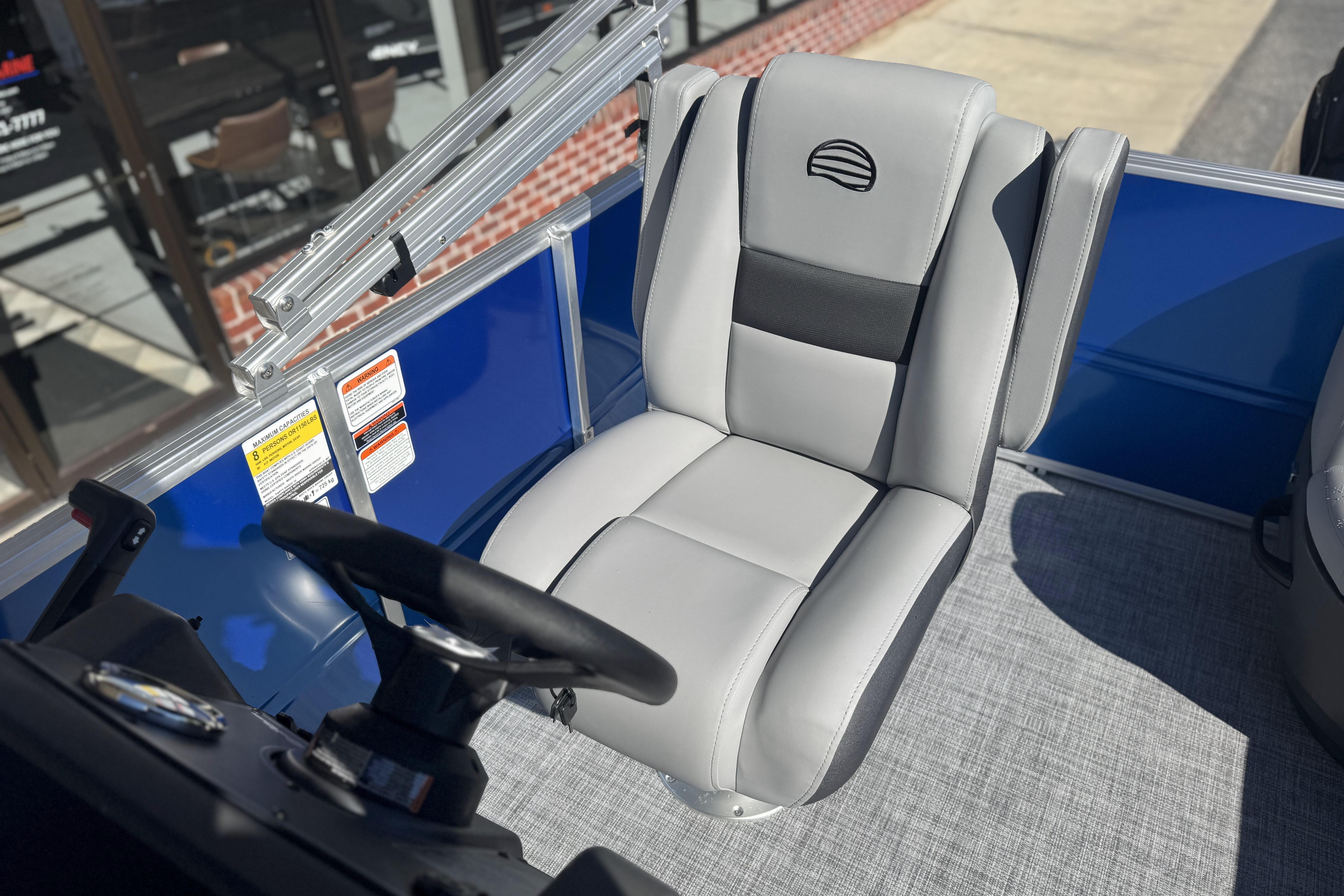 2026 Sun Tracker Party Barge 16 DLX boat seat and steering wheel, blue and gray interior.