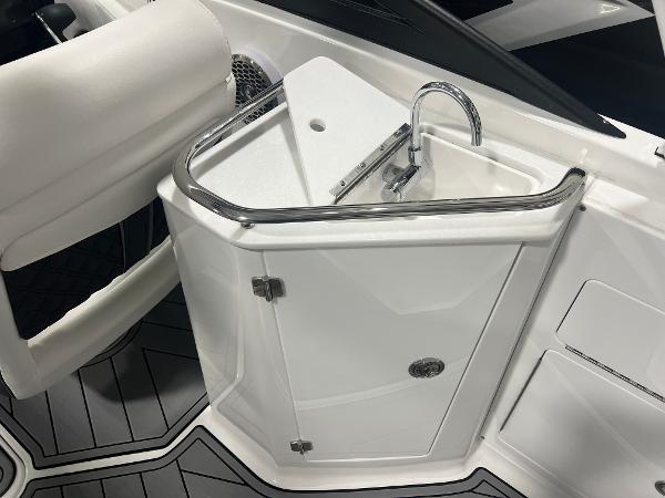 2024 Monterey M4 boat interior with sleek white sink and storage cabinet.