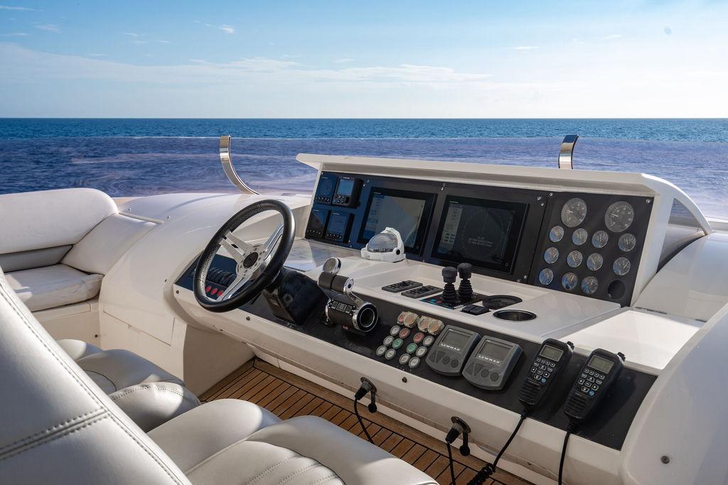 Helm of 2010 Princess 95 Motor Yacht with ocean view, featuring advanced navigation controls.